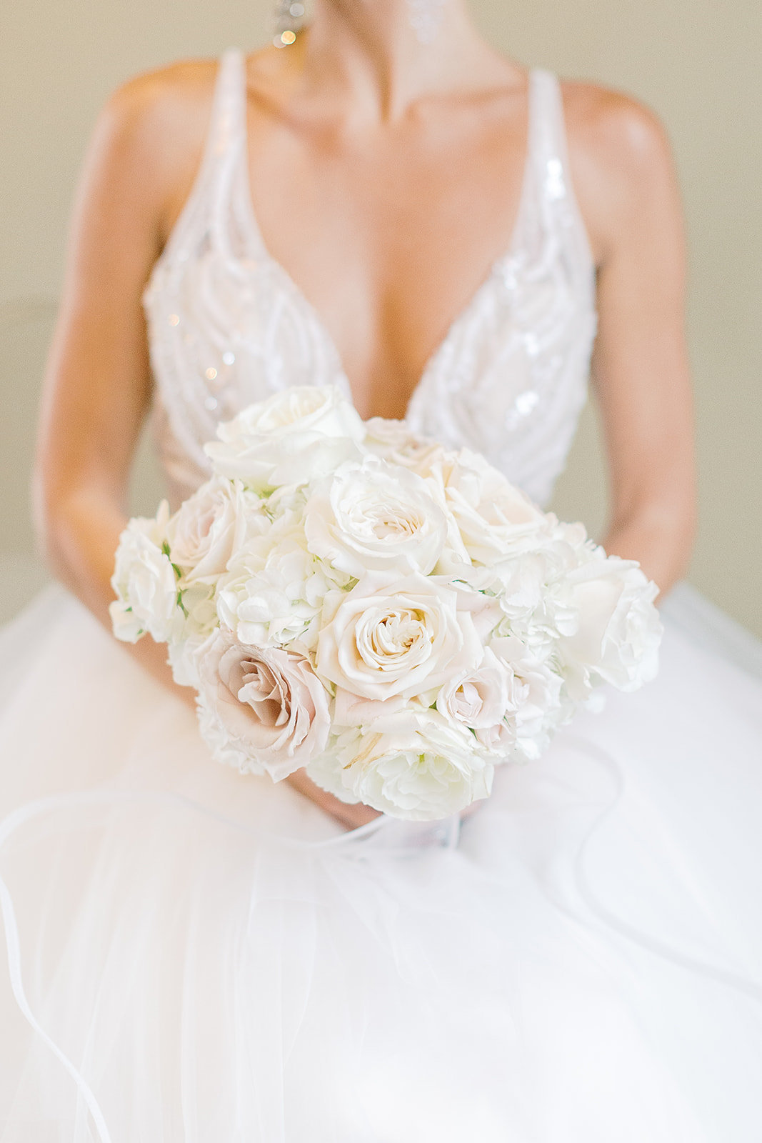 bride  holding bouquet of white roses