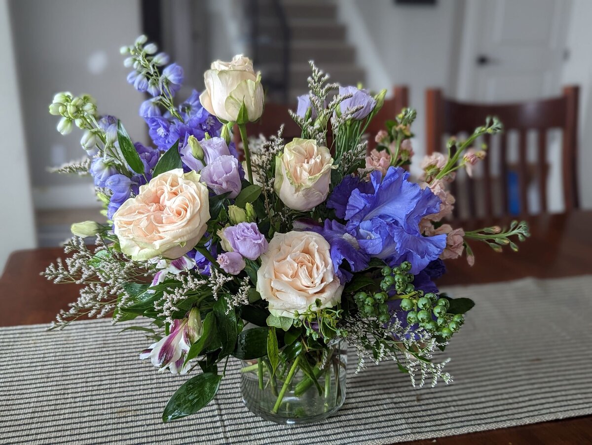 white funeral flowers with purple and pink in vase 2