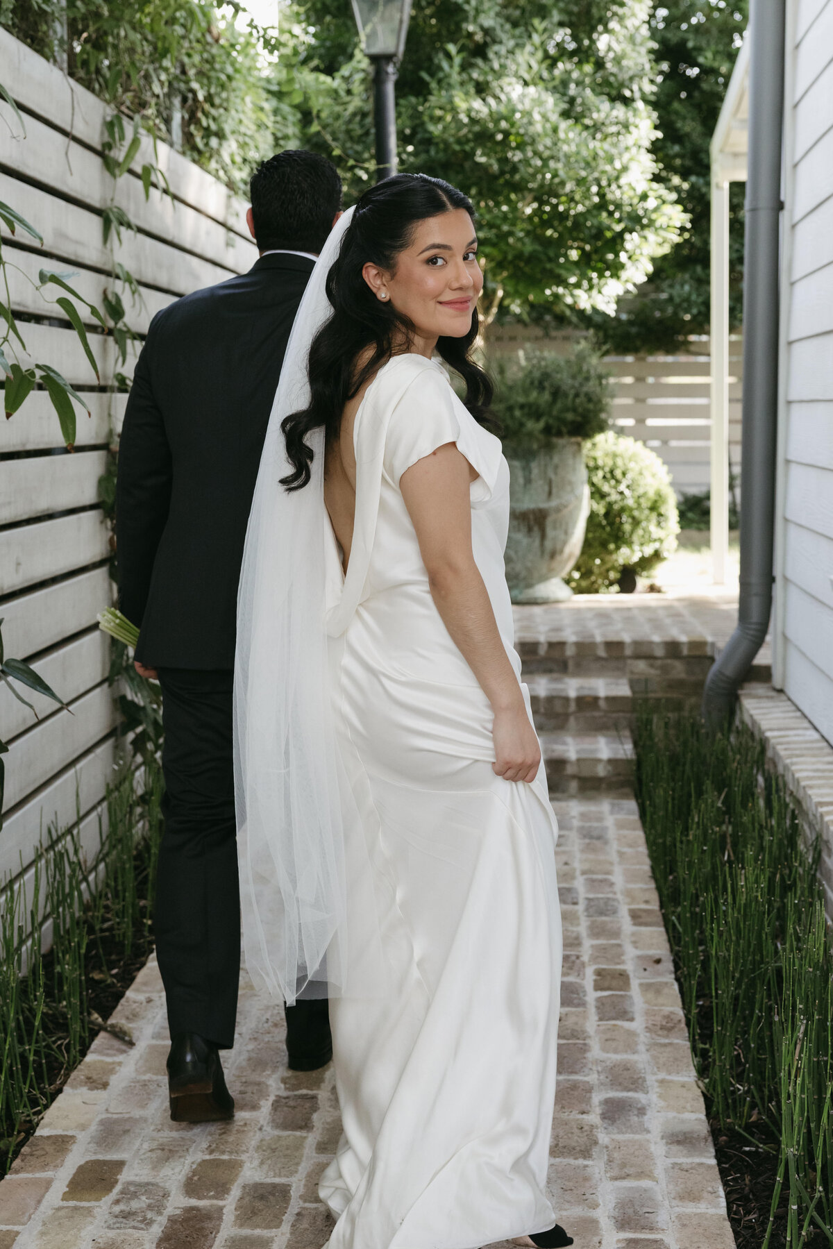 Bride looking at photographer during her wedding photos in austin. 