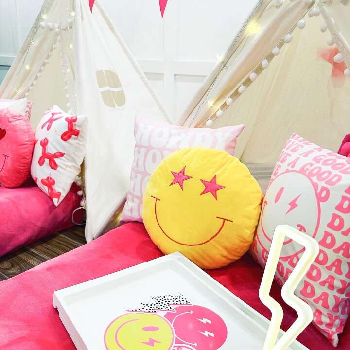 pink teepee beds with smiley face pillows