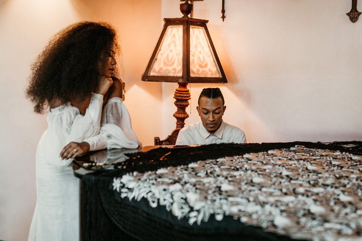 groom playing piano for bride