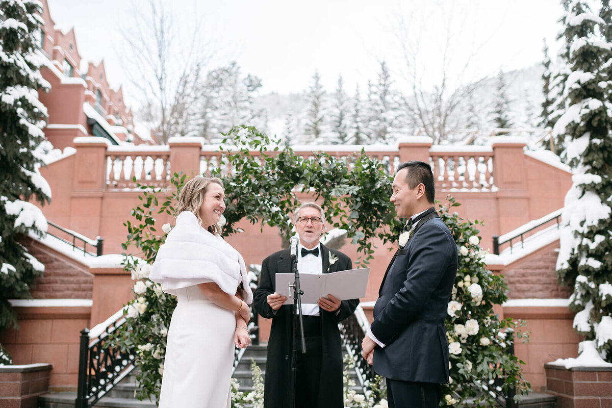 Bride and Groom exchange vows at the altar at their St. Regis Aspen wedding.