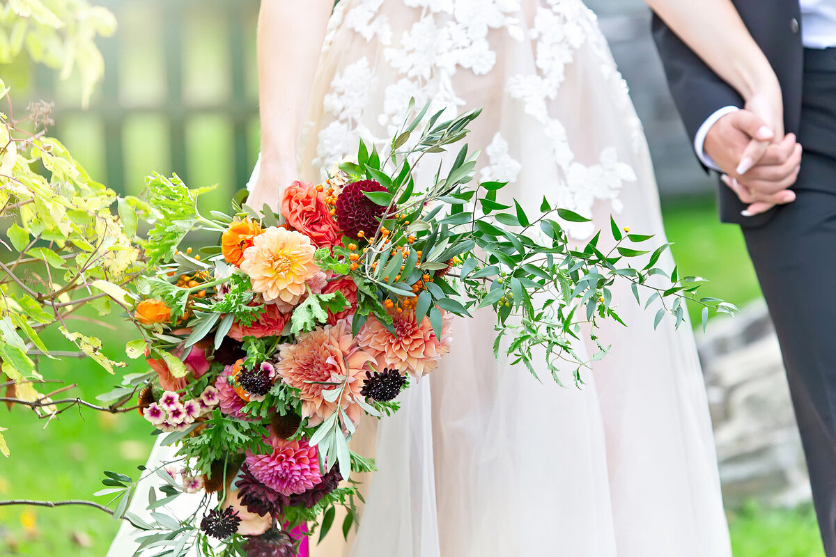 Tuscan dream wedding floral décor with burnt orange, yellow, plum, and baby blue blooms