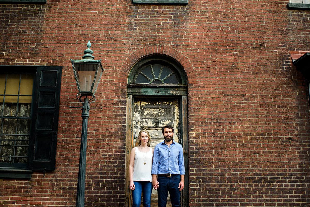 A couple in front of a south philly doorway.