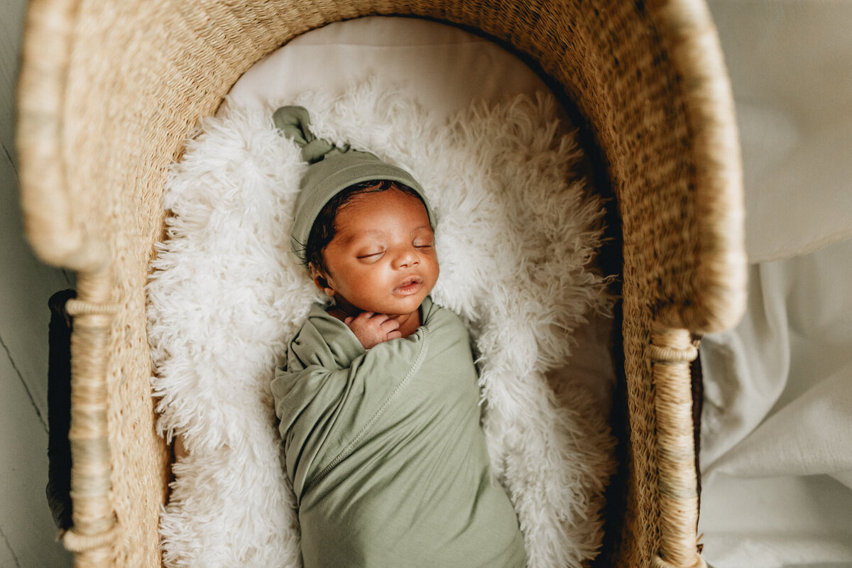 newborn baby sleeping in a crib.