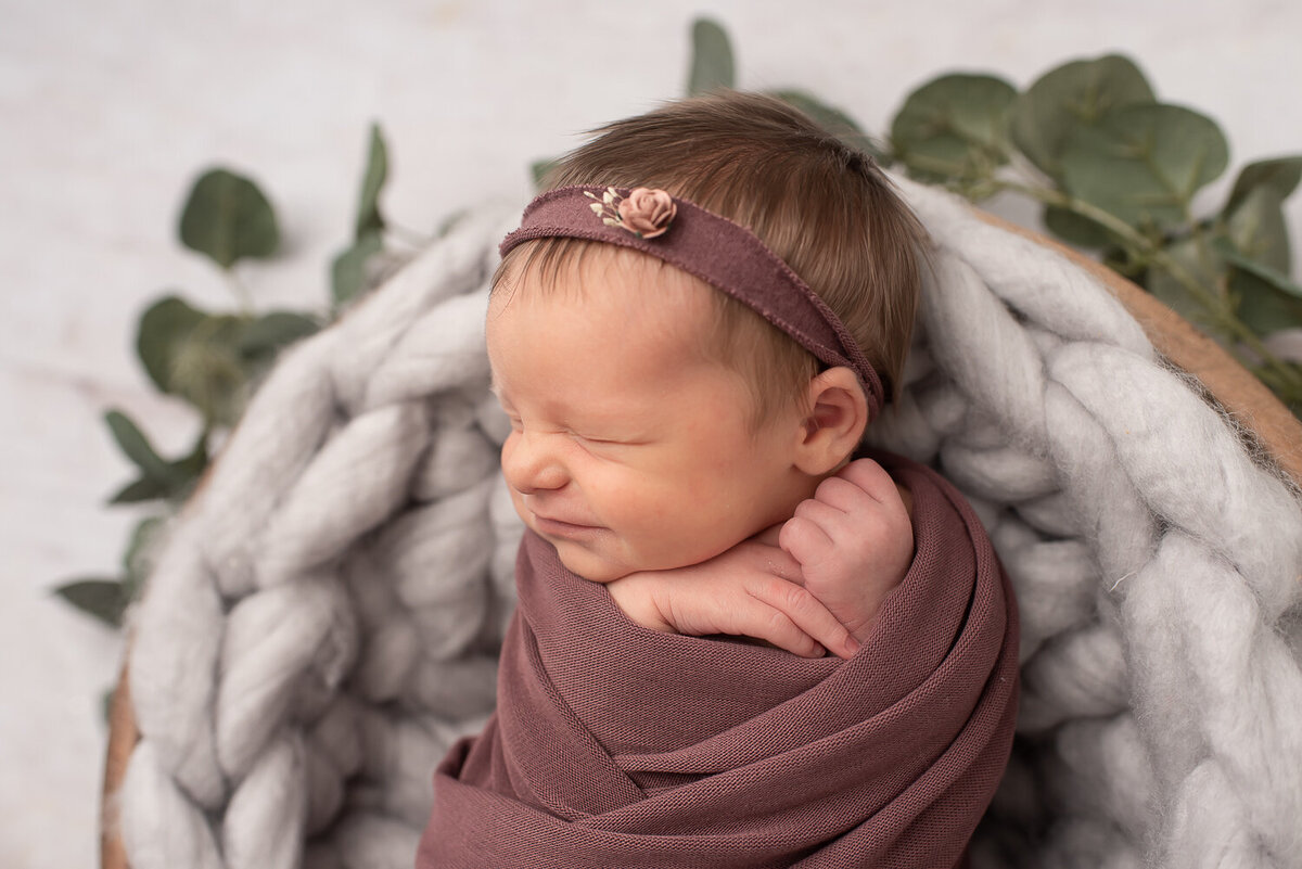 Close up of baby girl dressed in purple, squishing her face together | Sharon Leger Photography || Canton, Connecticut