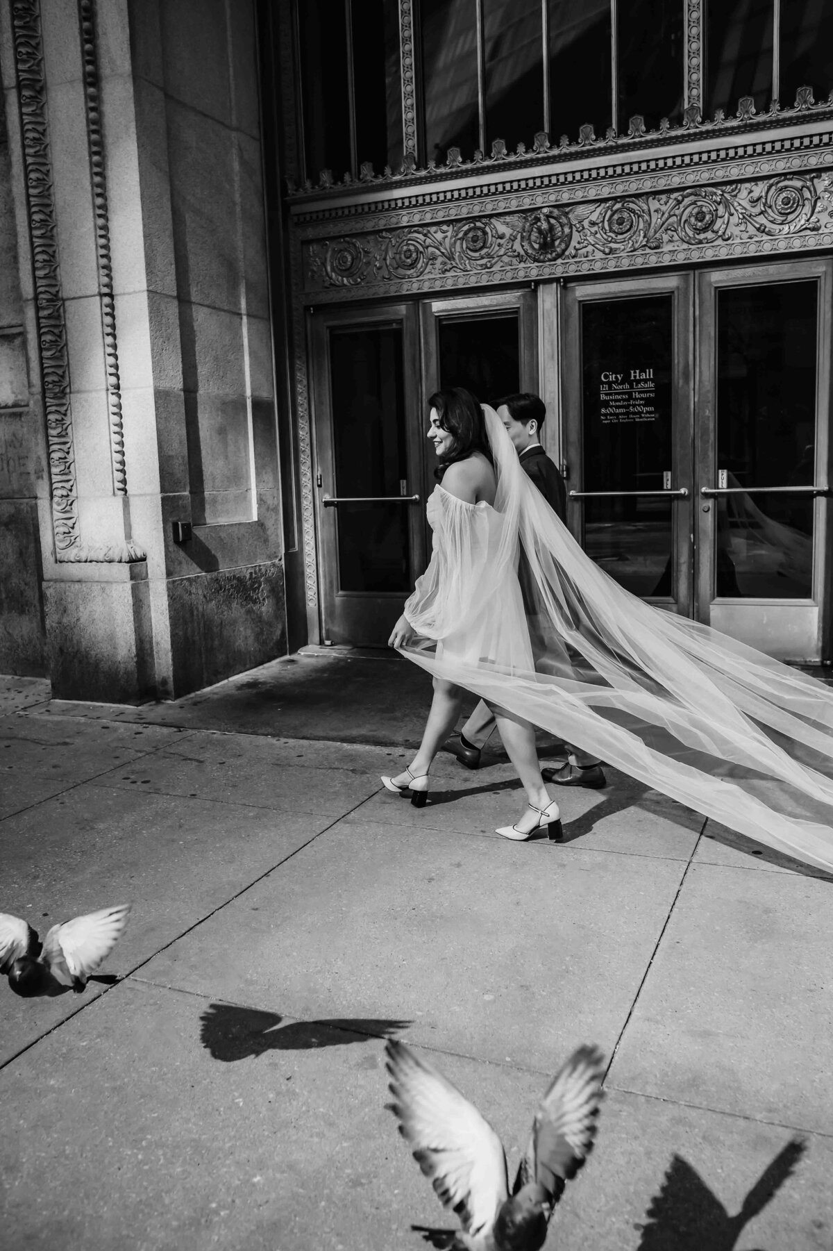 Bride and groom walk past birds outside in Chicago