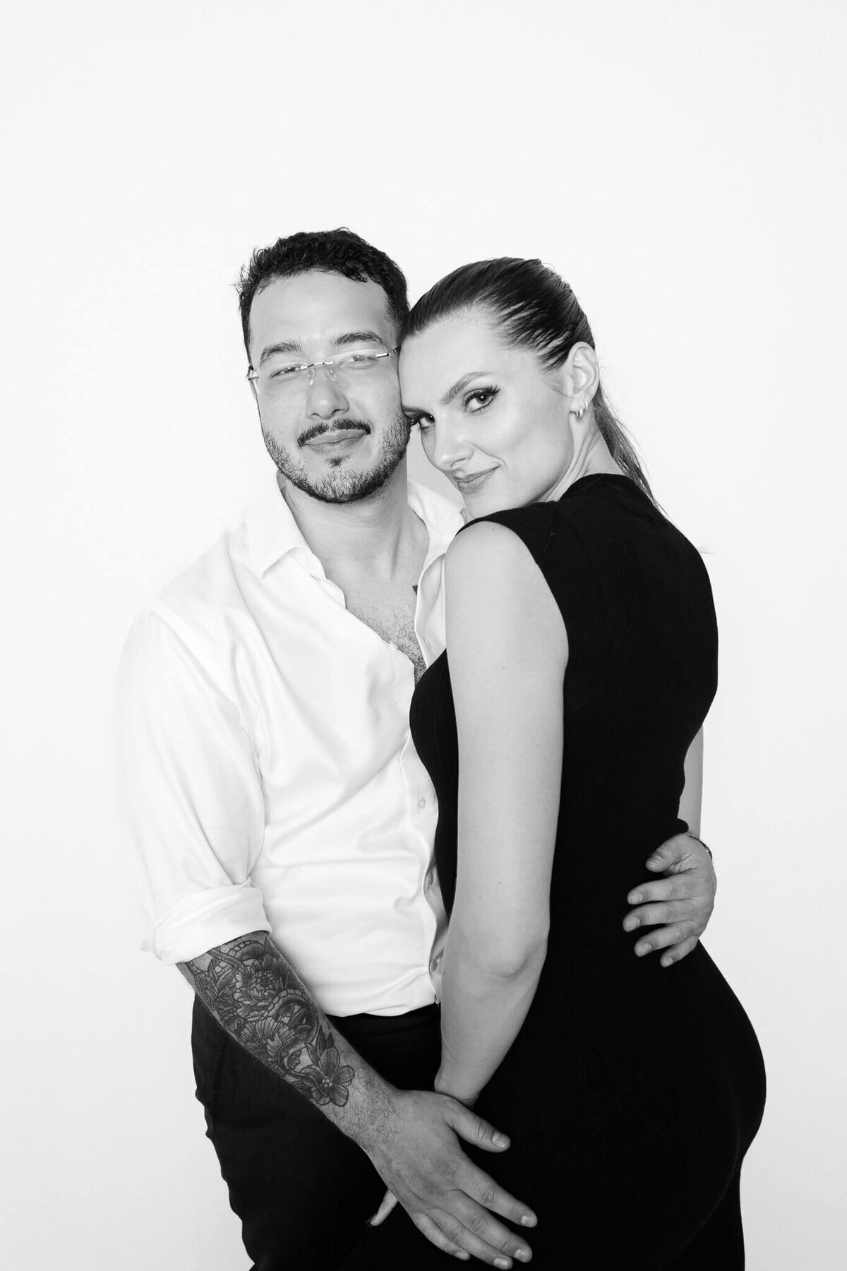 A stylish couple poses closely in a black and white portrait taken at a Phoenix photo booth rental by Monochrome Portraits, known for its elegant and modern event photography.