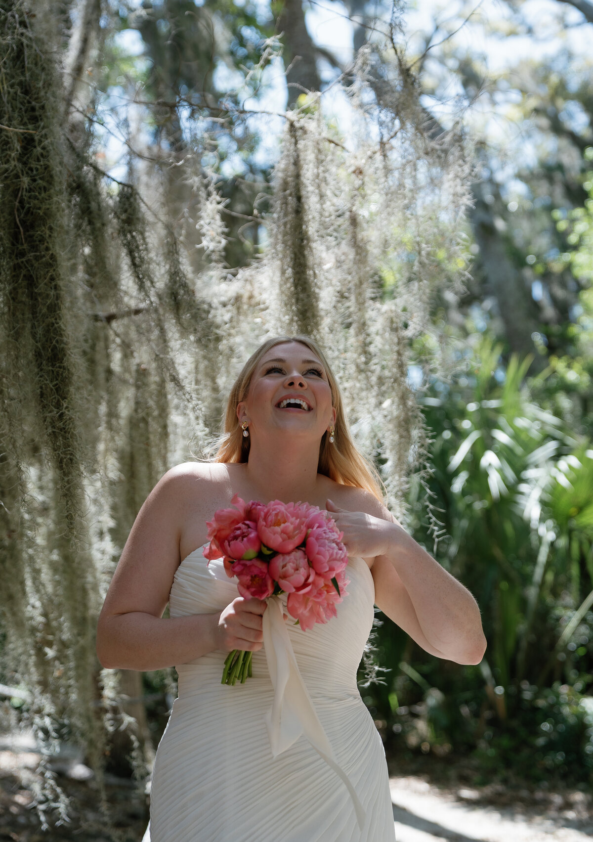 Portrait of Bride holding bouquet and laughing by film wedding photographer Shelby Ann Photos