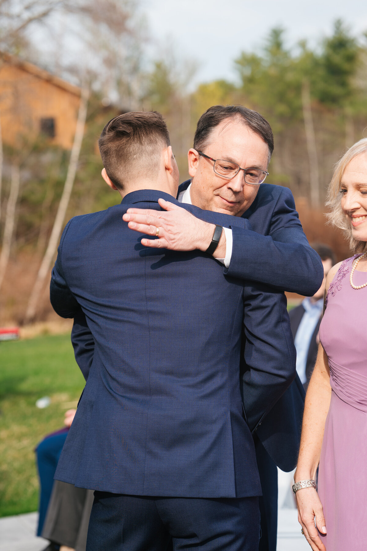 Couple exchanging vows under a floral arch in New England