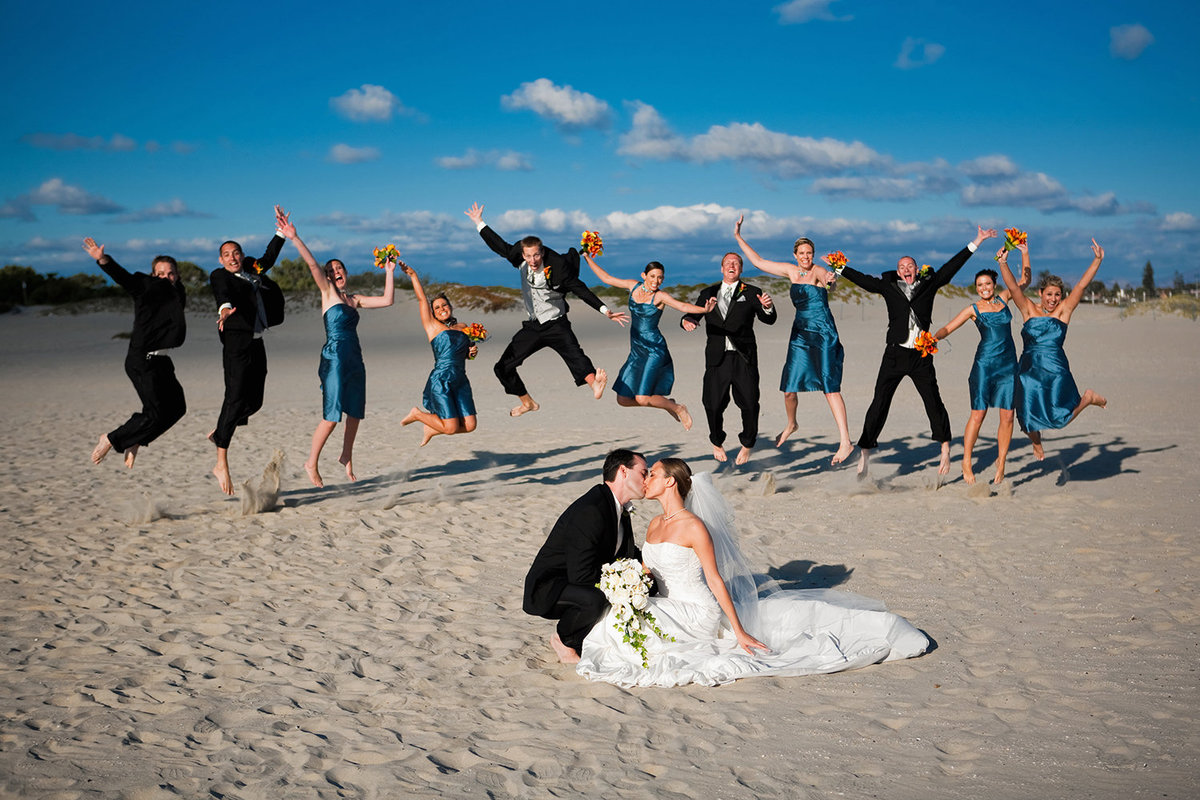 wedding photo beach shot bridal party jumping