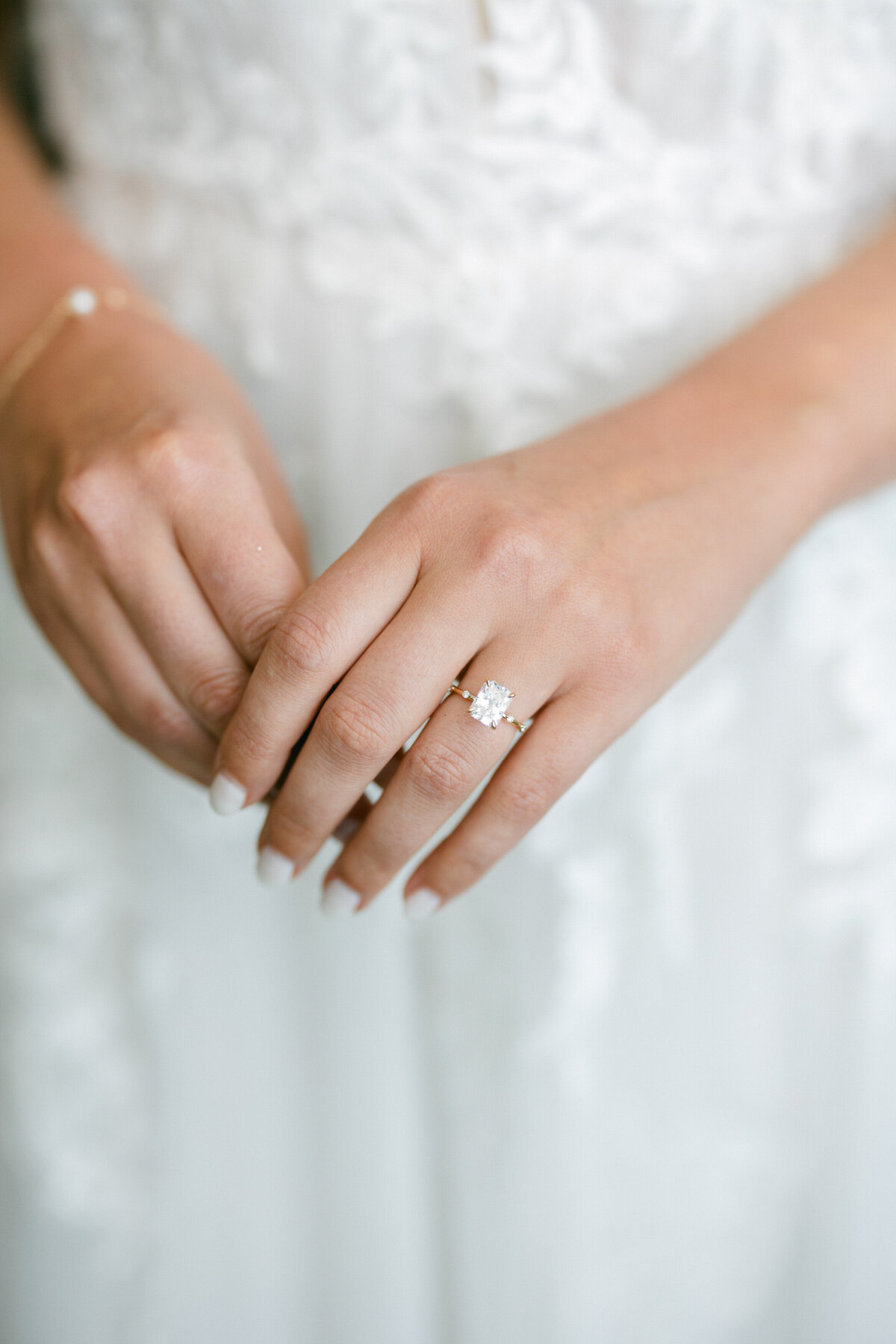 Close-up of bride’s hands and diamond engagement ring before Cancun wedding, shot by Philadelphia photographer.