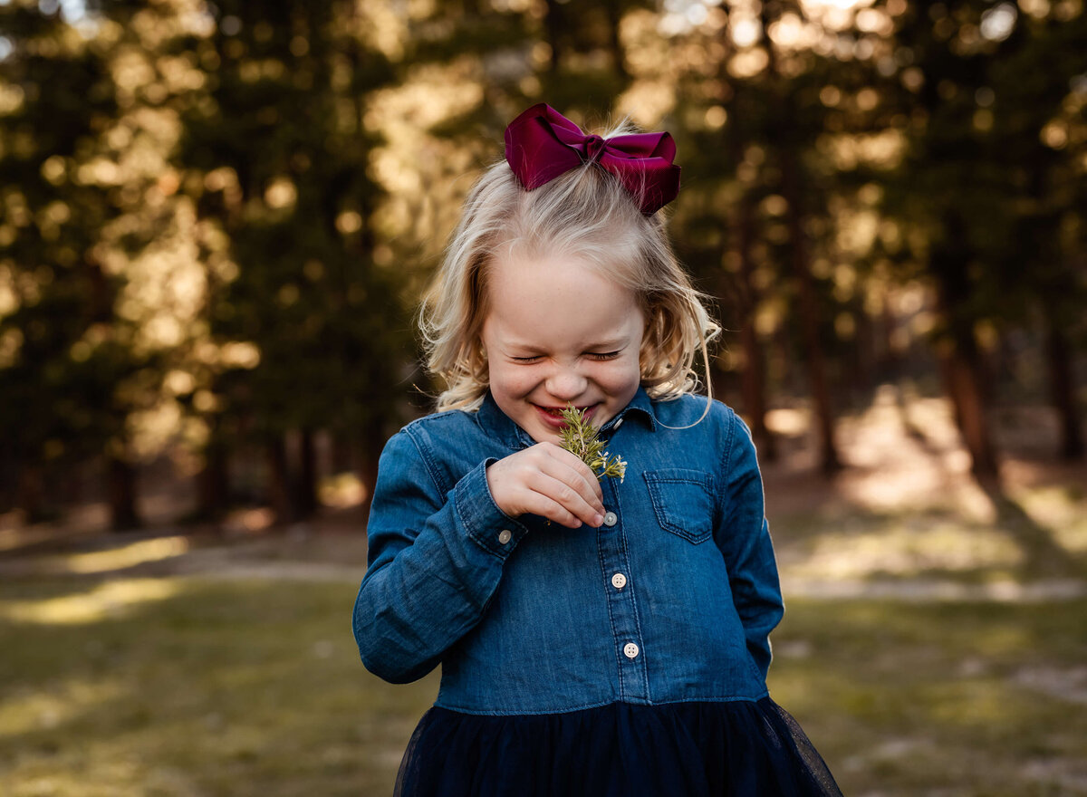 girl-smelling-flower