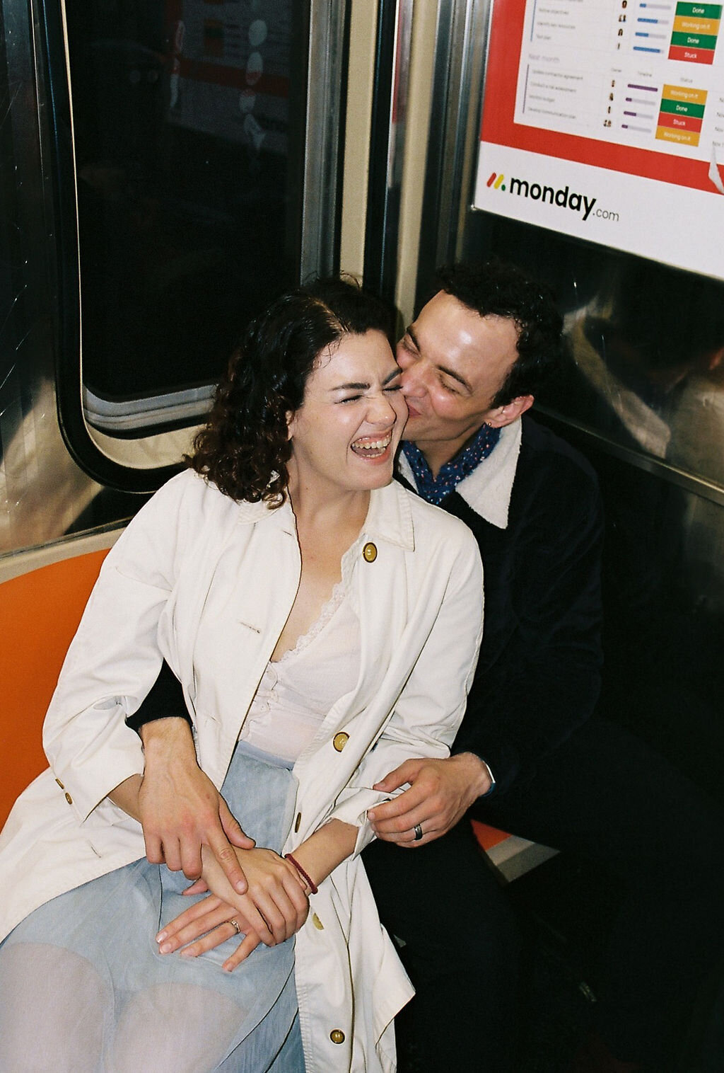 man kissing woman on subway in new york city