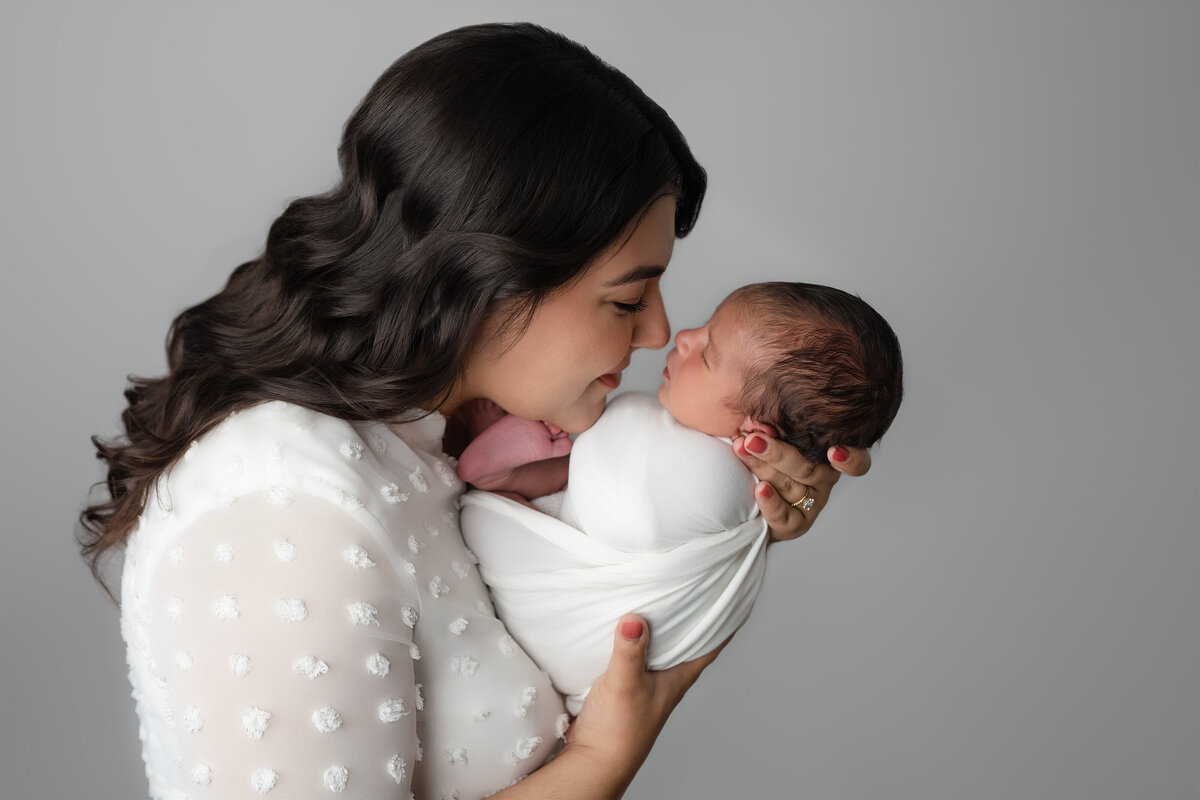 Studio family photo of mother holding newborn face to face | Meraki Photographic Creations Paris Ontario