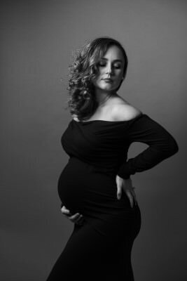 Professional black and white maternity portrait by St Augustine family photographer showcasing elegant studio lighting and pose