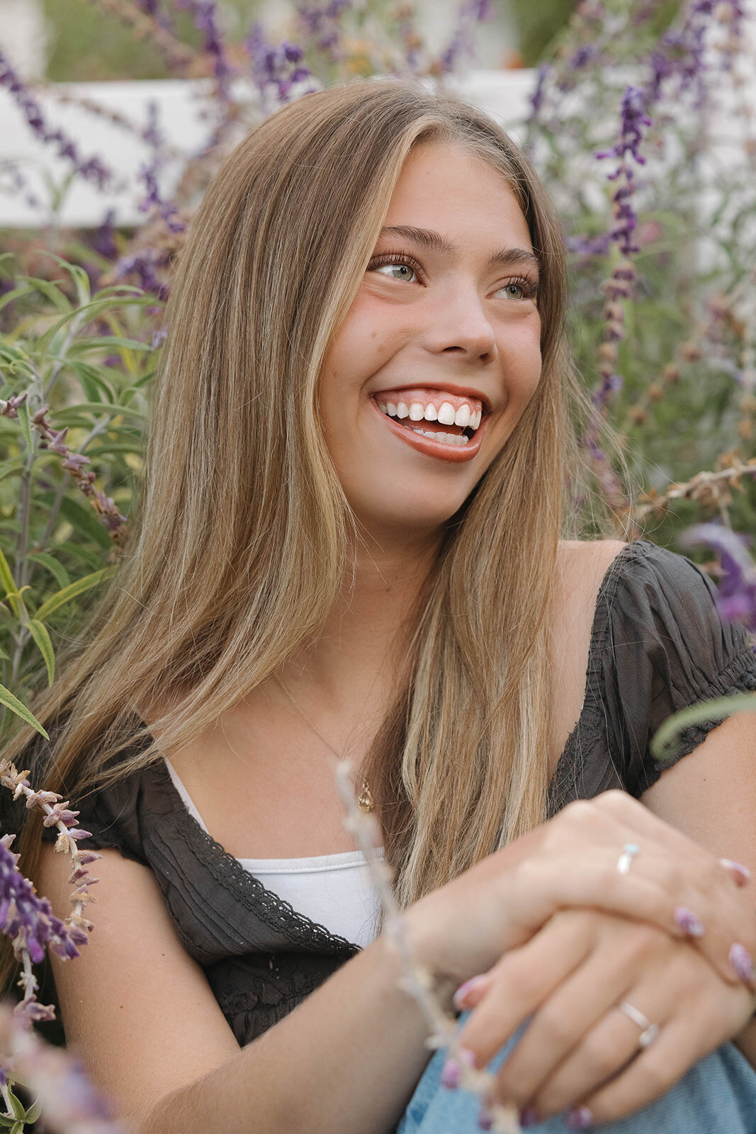 Senior girl laughing in a lavender garden
