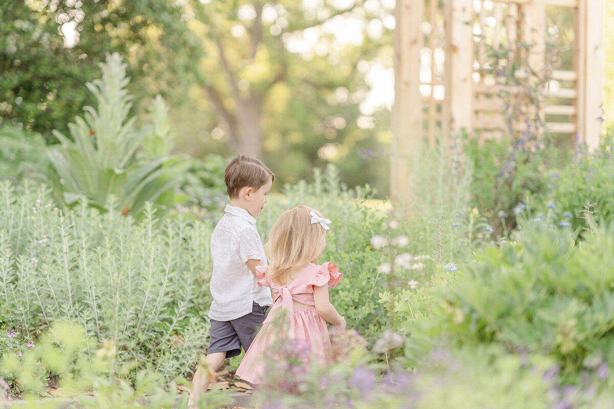 siblings walking in the garden during Leesburg, Virginia family pictures