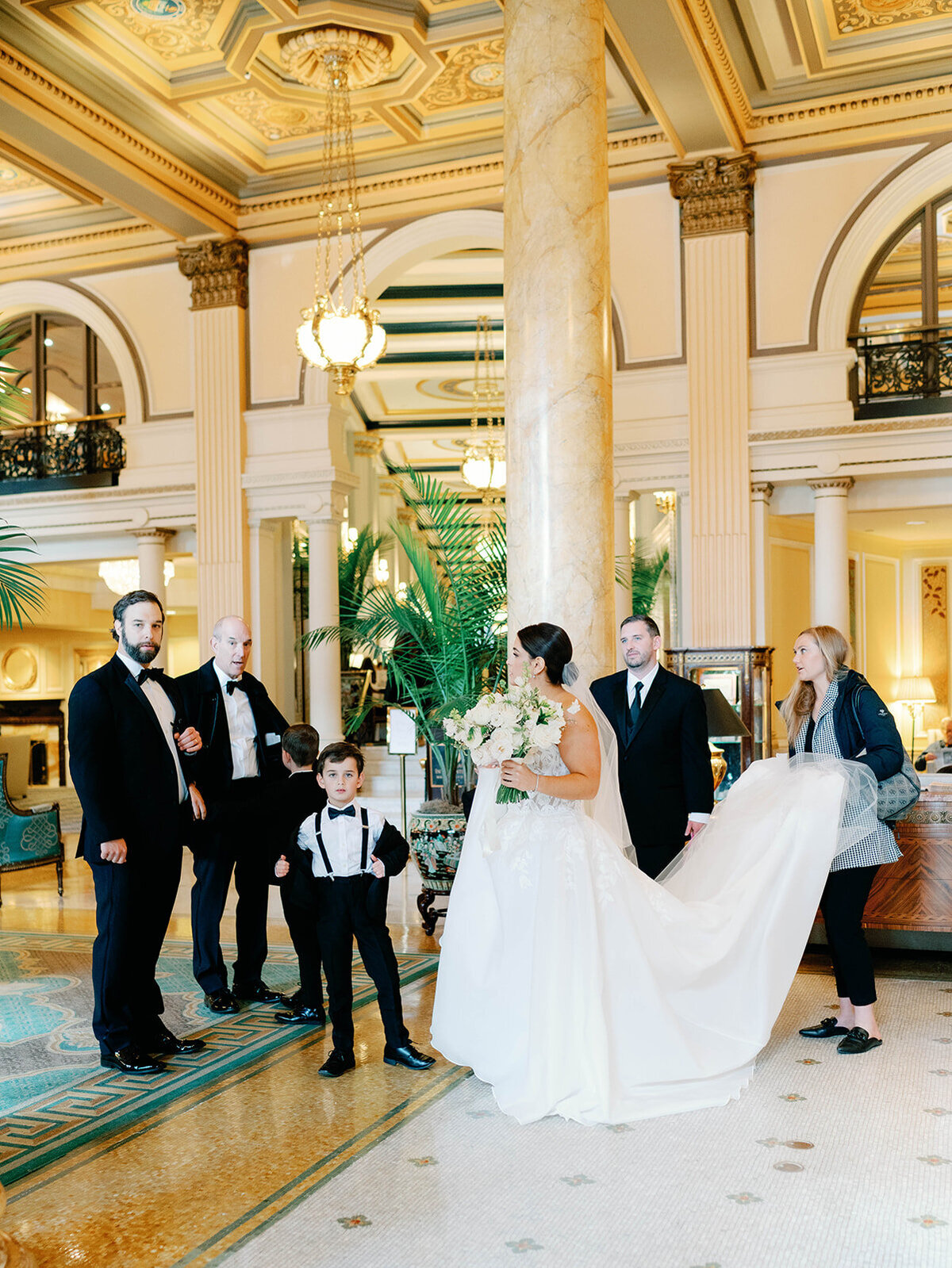 Bride stops to talk with family in the Lobby of the Willard