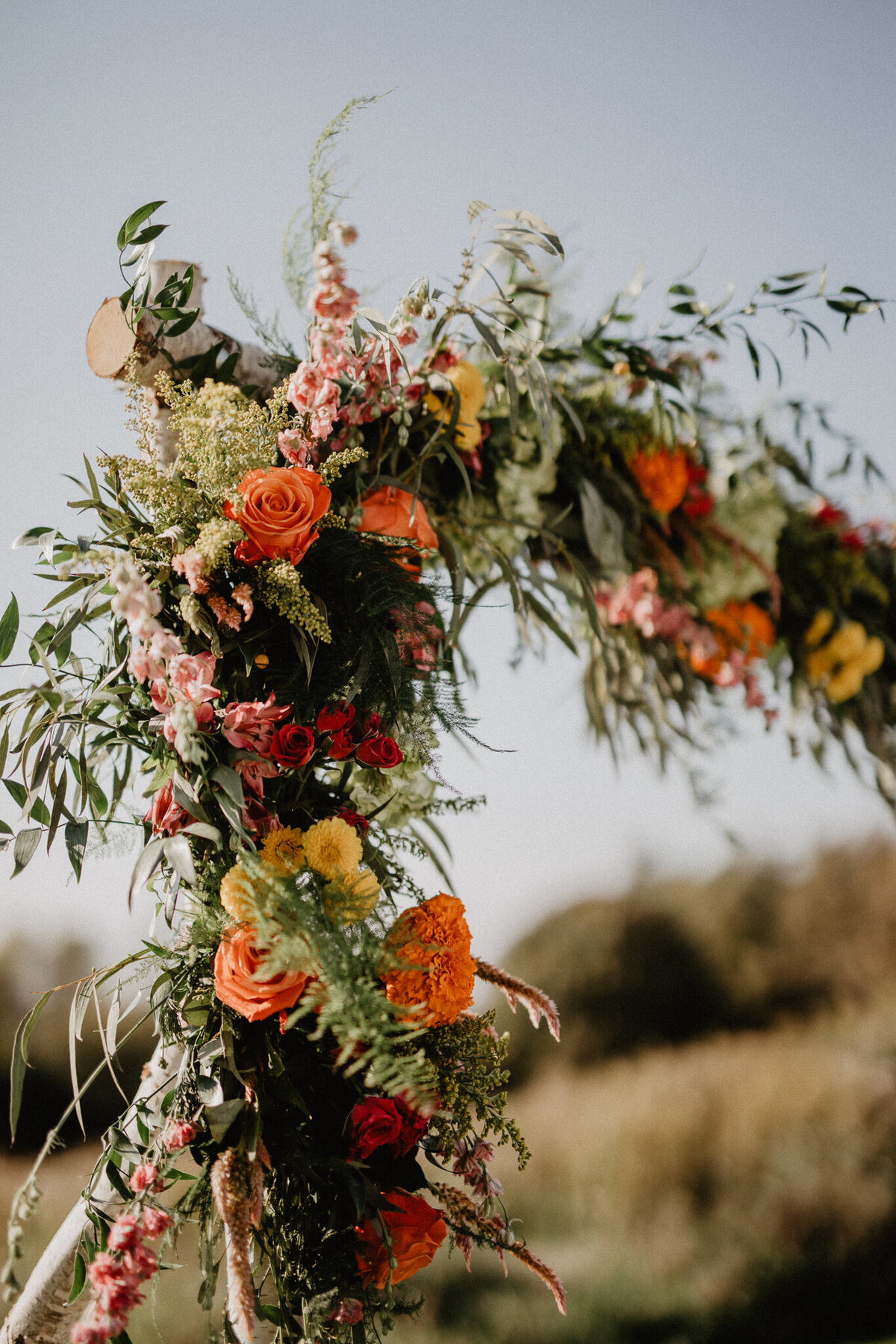 colorful-wedding-ceremony-arch-florals