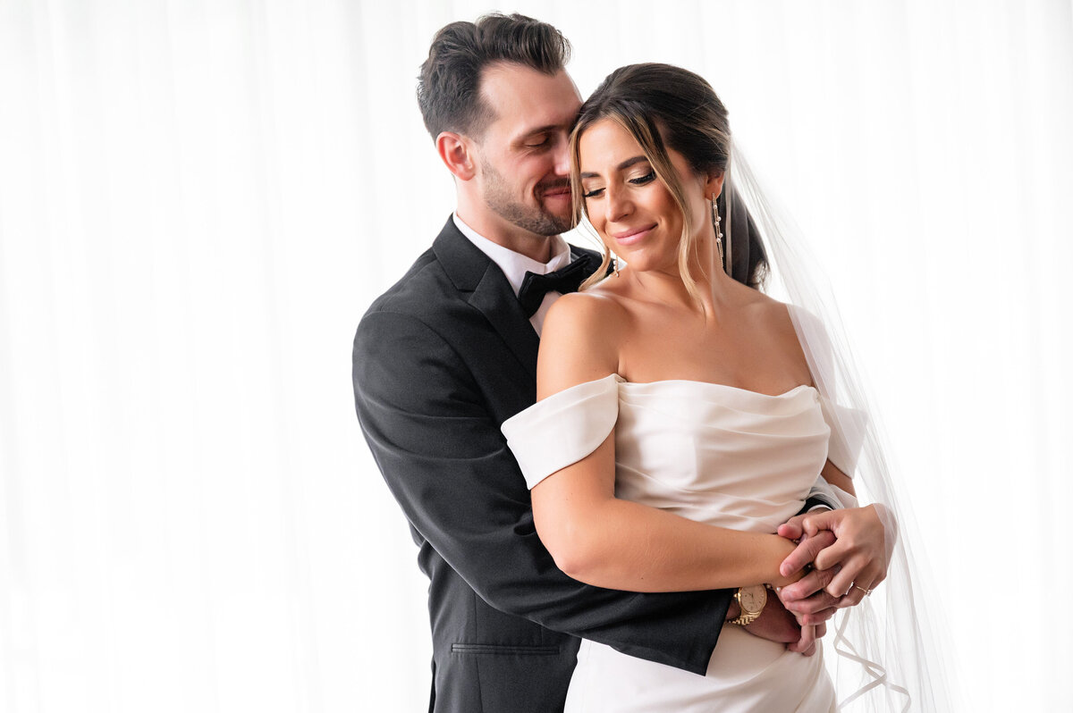 bride and groom classic wedding picture on white backdrop