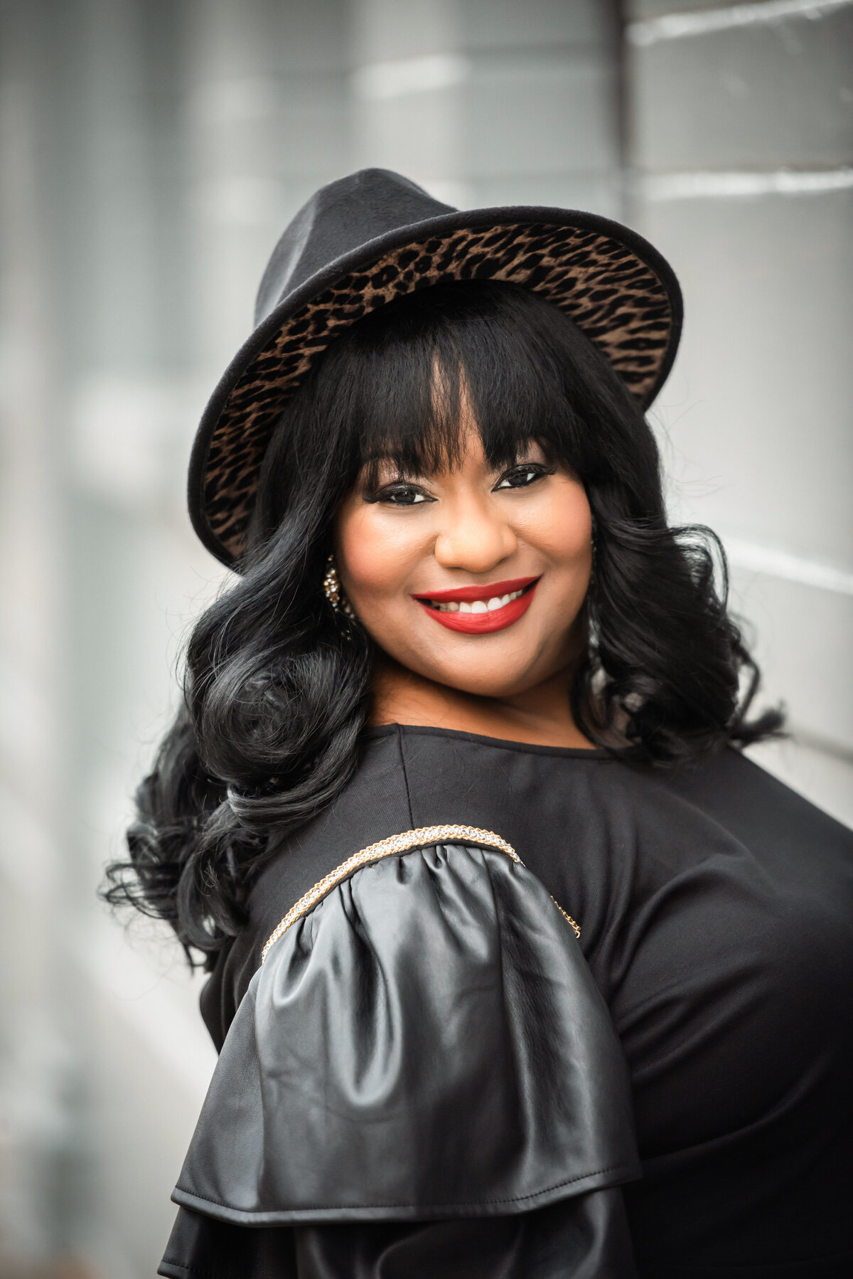 A woman smiling in a hat