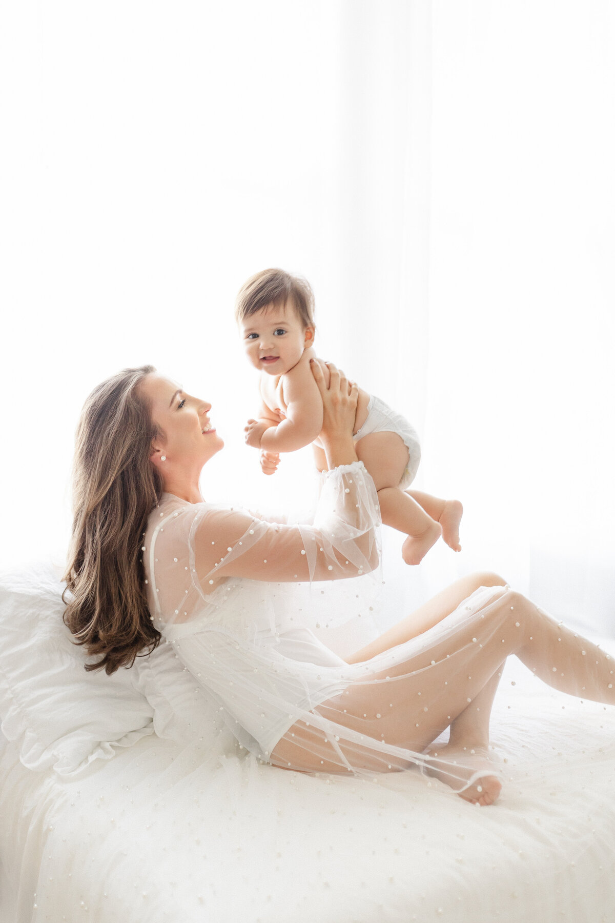 Luxury motherhood moment in Tampa studio in soft, editorial light