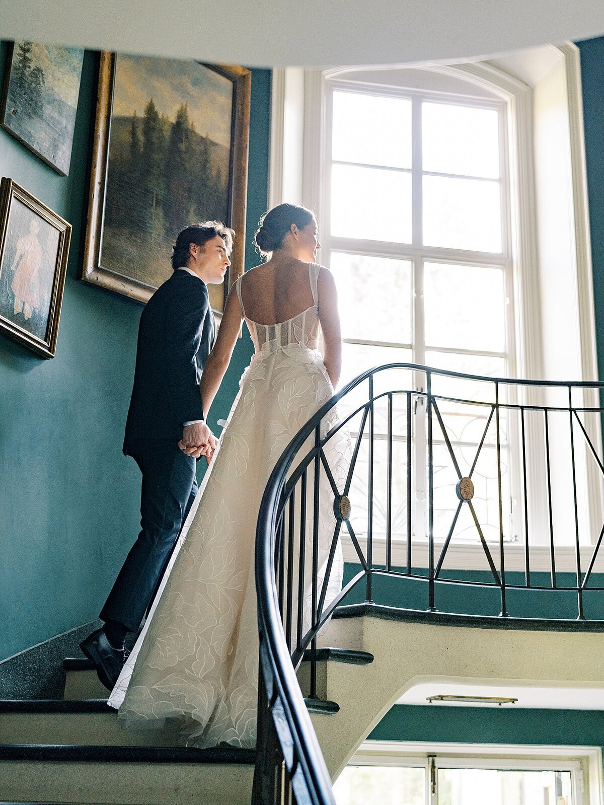 Bride and groom walking up staircase at Greencrest Manor wedding