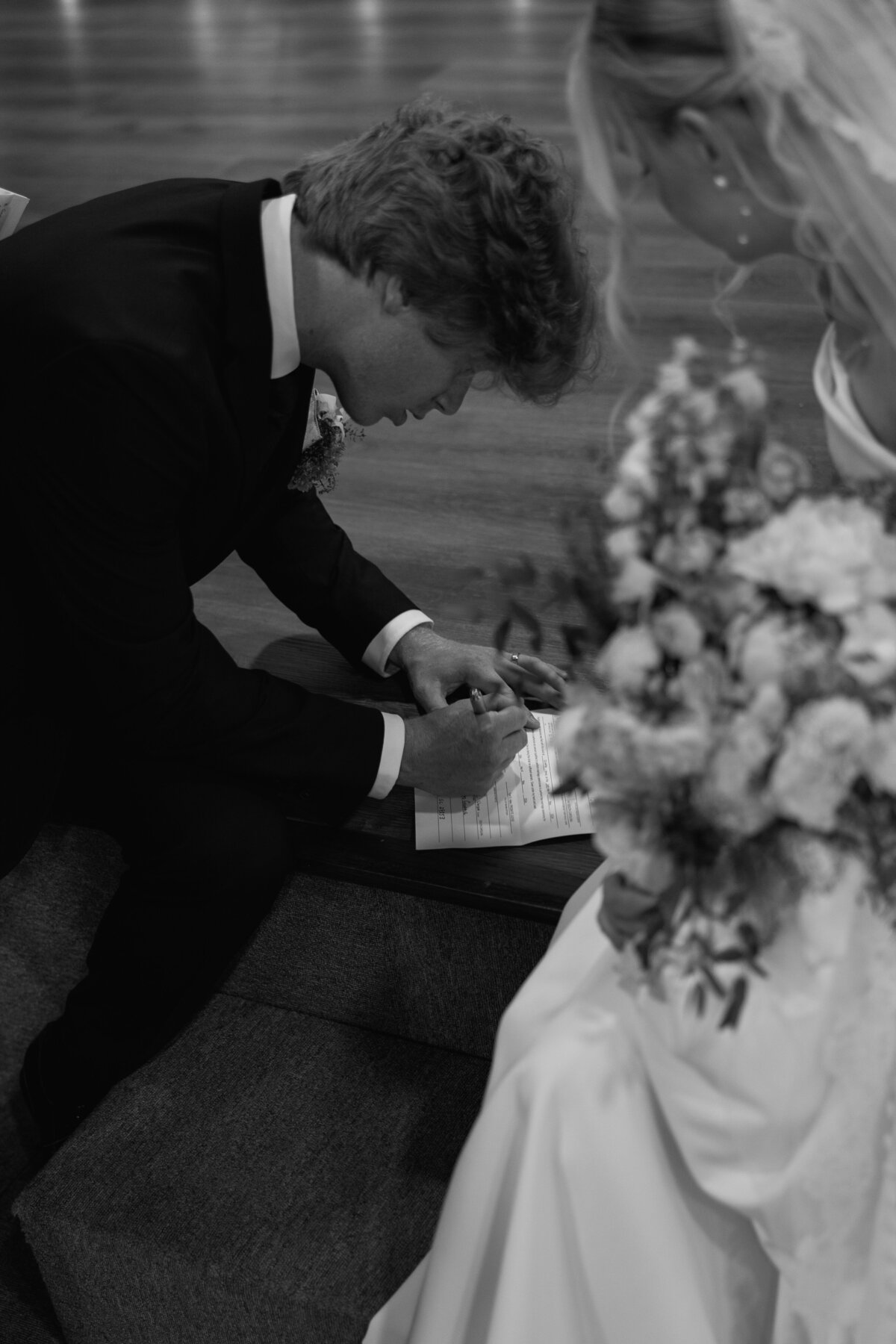 Bride and Groom sign their marriage license