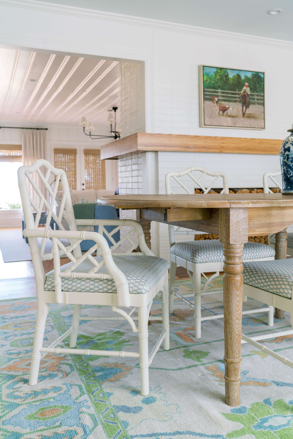 oyster creek studios happy valley white chairs around a wooden dining room table with white and green rug white chair on blue and green rug around a wooden dining room table