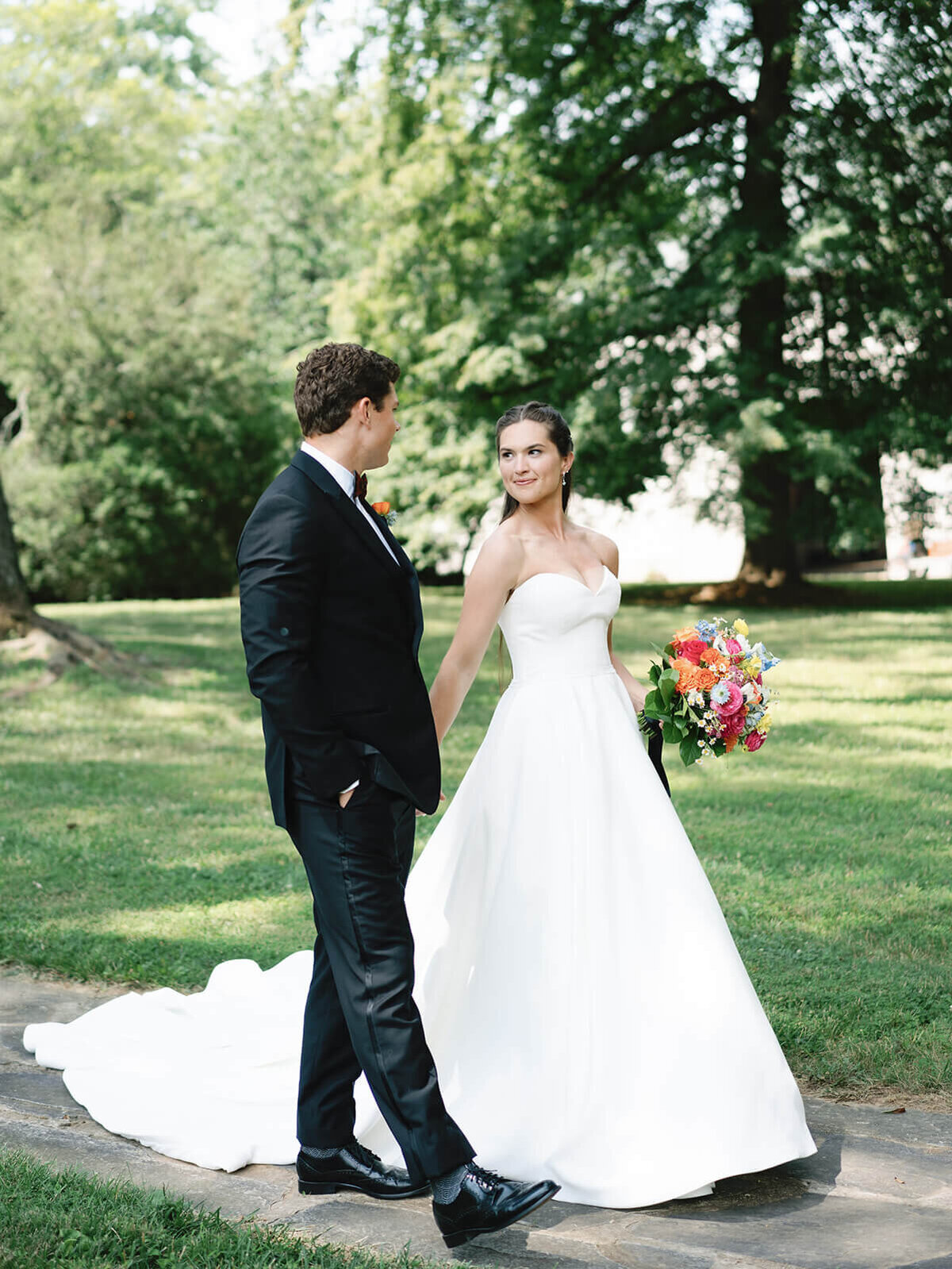 Bride and groom walk down a pathway at their wedding at  their Middleburg wedding.