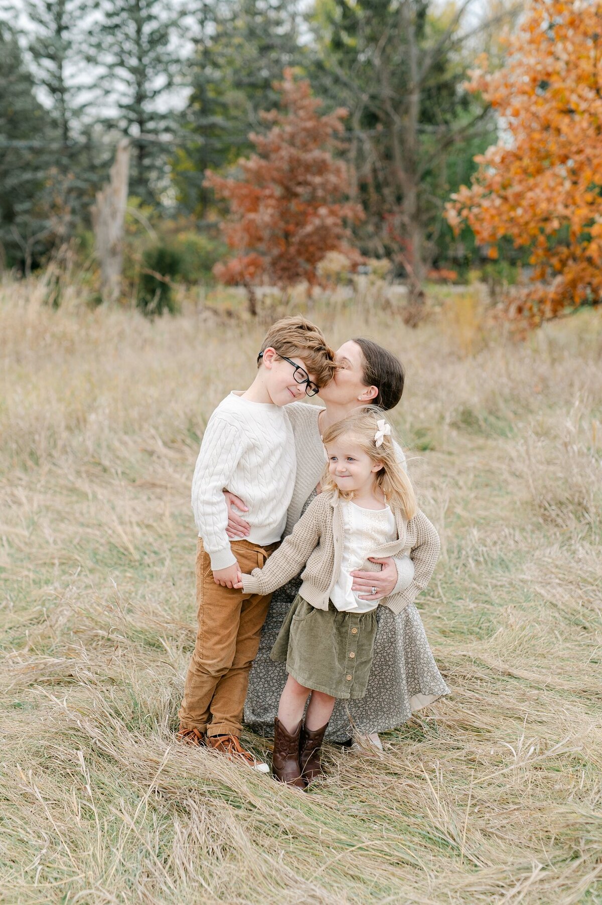 Mom kisses her children during a family photoshoot in Milwaukee