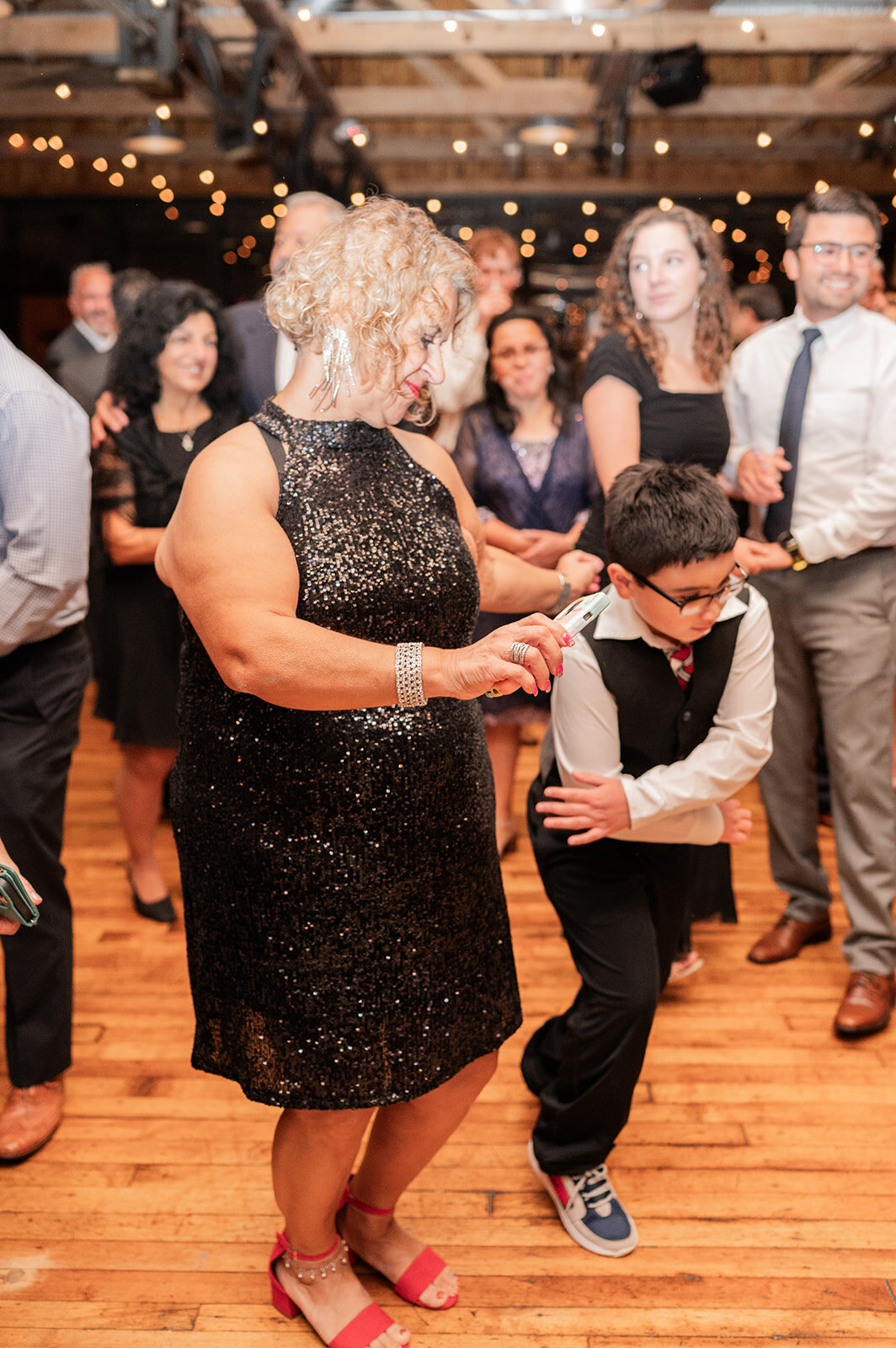 guests enjoy themselves during wedding reception on dance floor