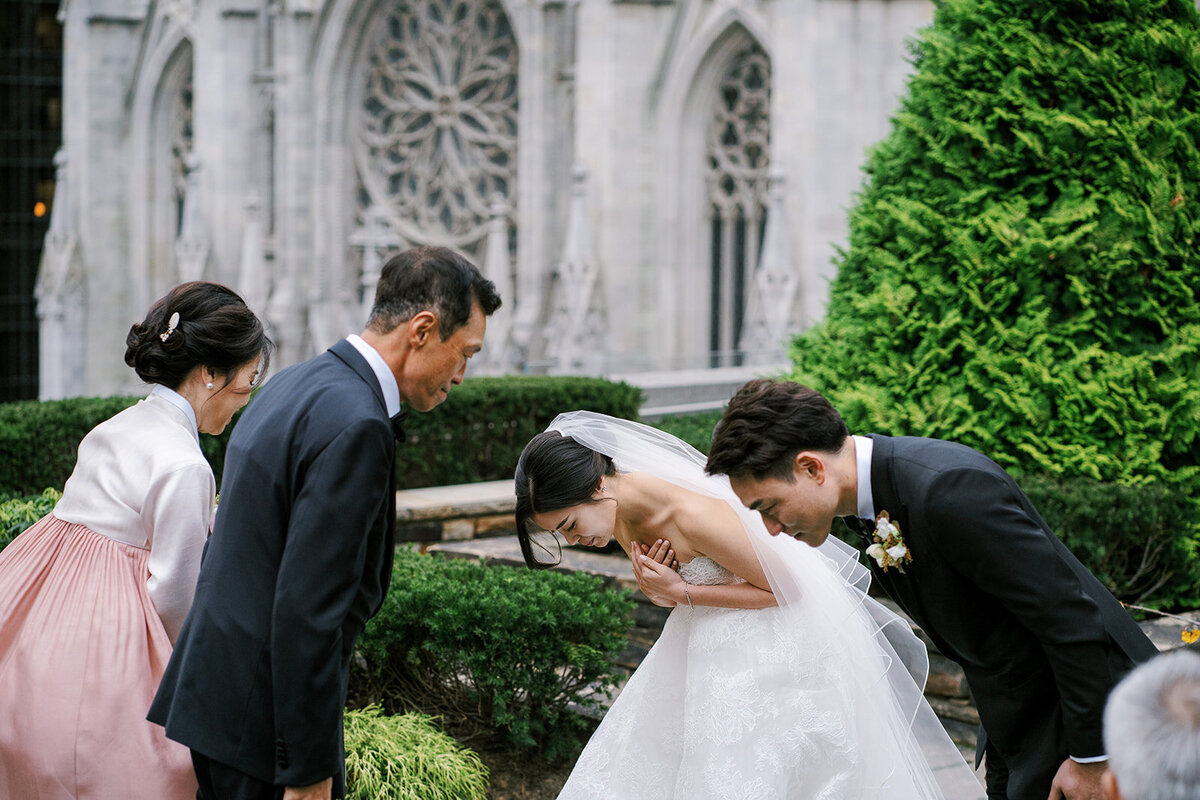 Korean bride and groom bowing to parents during wedding ceremony