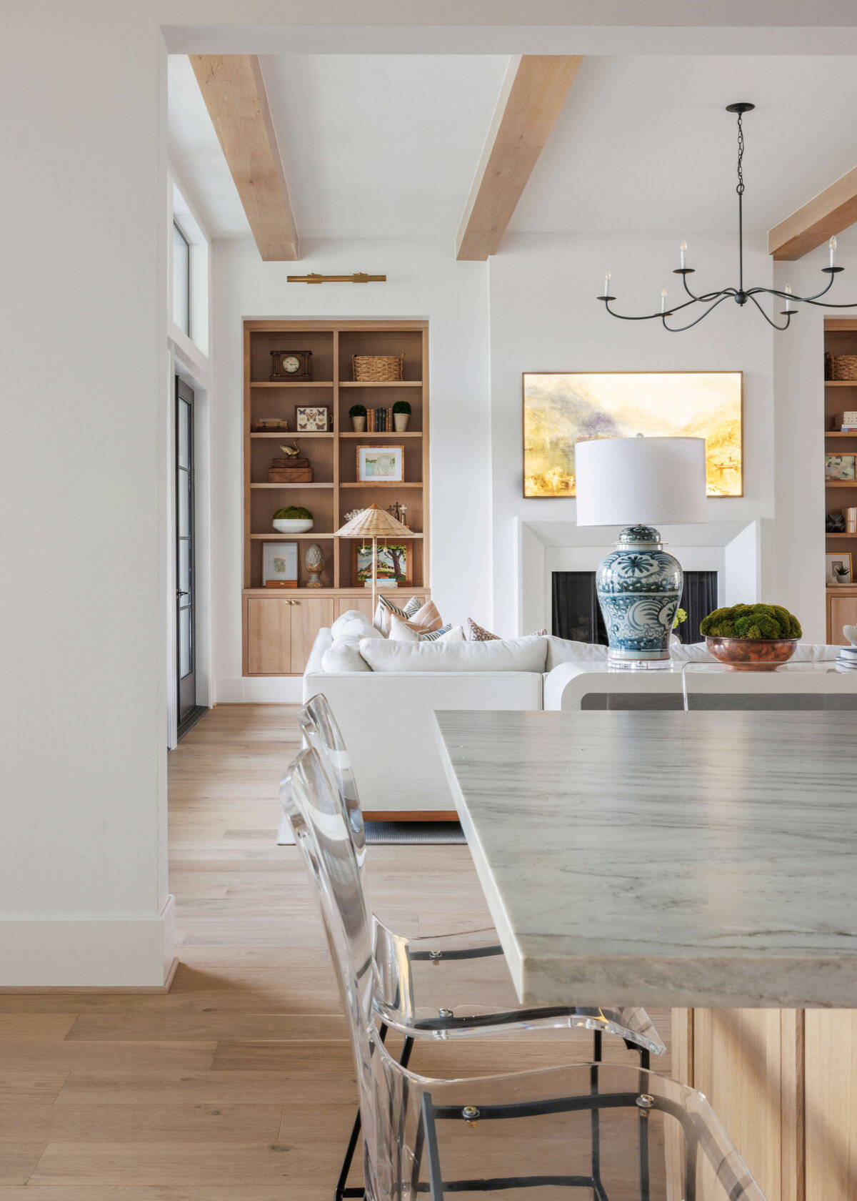 oyster creek studios missouri city new build marble counter with wooden cabinets overlooking living room with wooden shelving