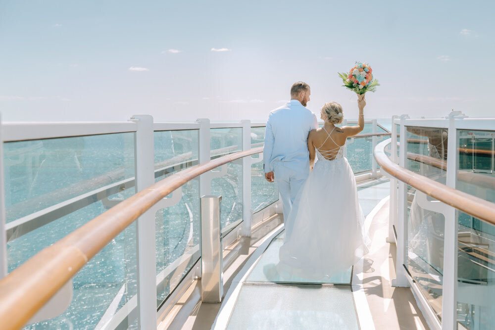 bride and groom cheering on a cruise ship