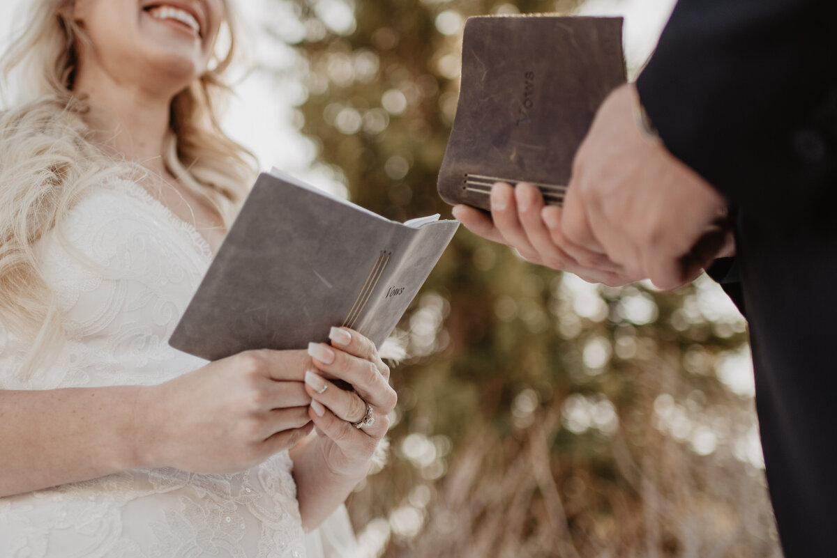 Jackson Hole Photographers capture close up of couple holding vow books