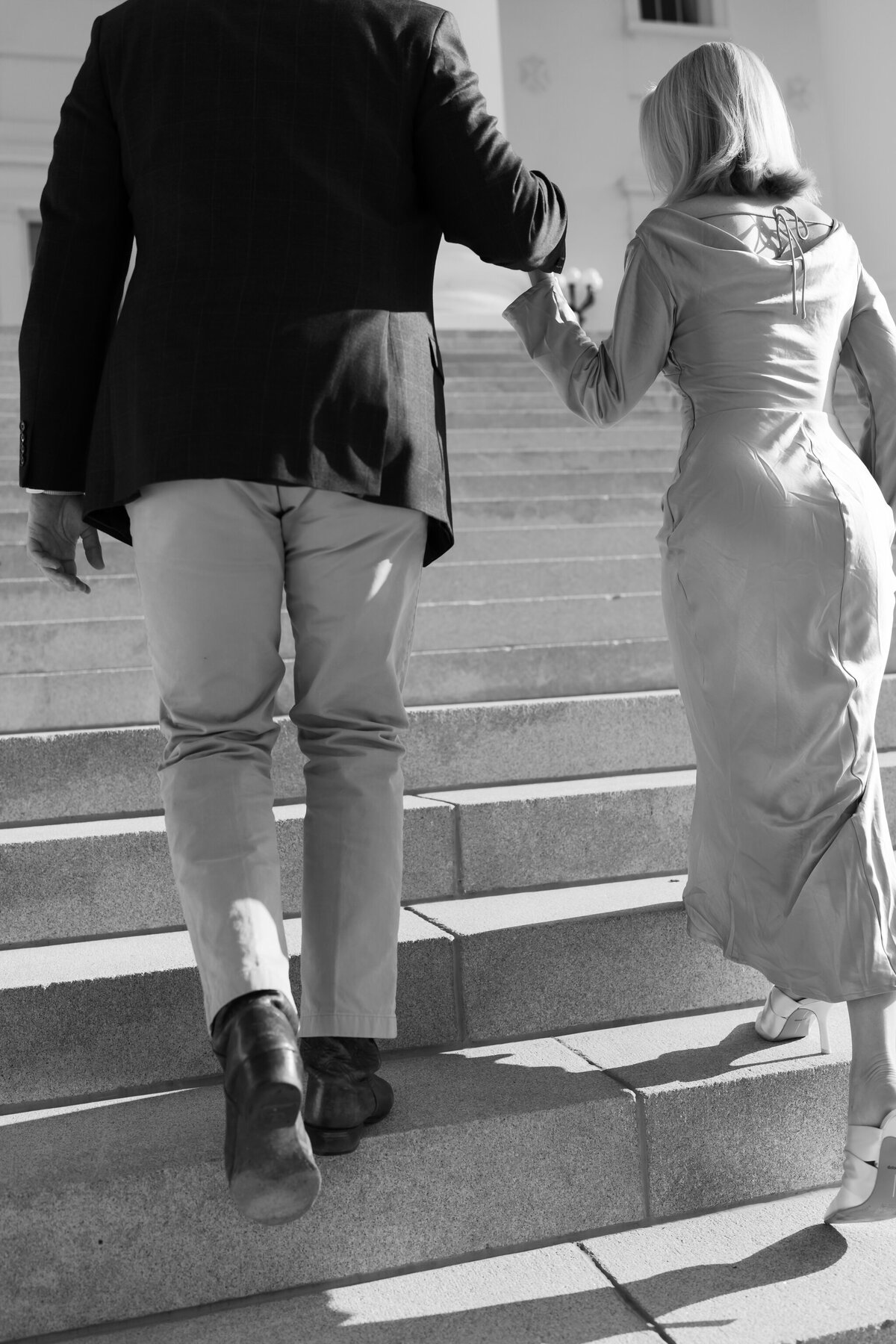 Virginia State Capitol Building Engagement Photos Richmond VA | black and white closeup picture of newly engaged couple as they walk up the white stairs of the VA Capitol Building
