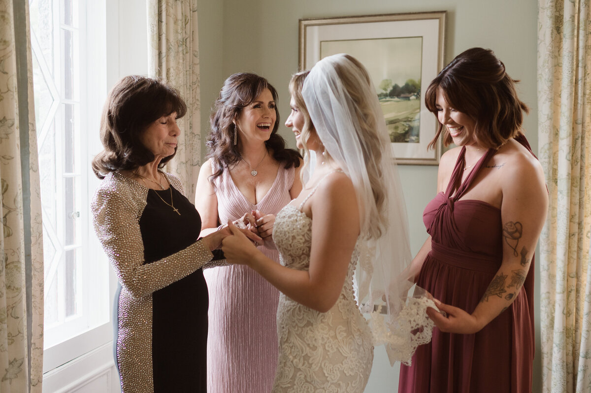 A bridal portrait of a bride getting ready with her grandma, mother and sister on her wedding day by Suess Moments NJ photographer