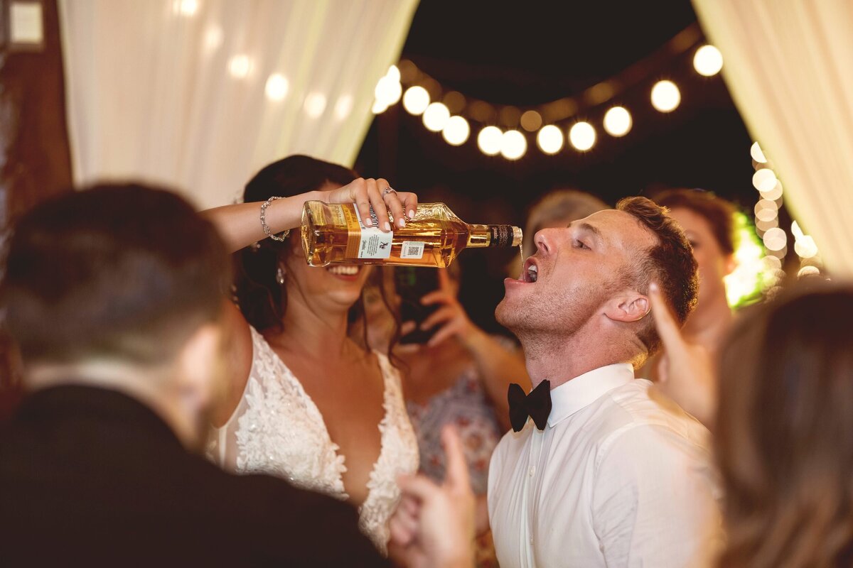 Groom drinking a lot of alcohol.