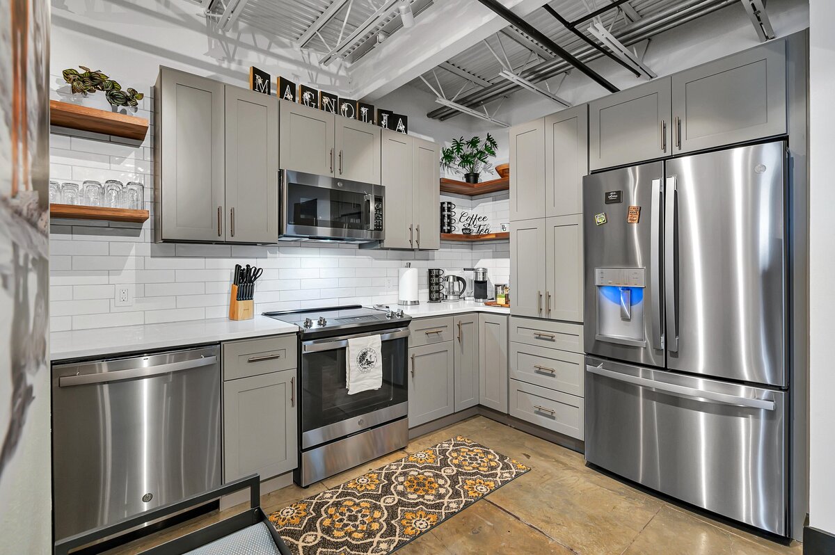 Full kitchen with coffee maker in this top floor two-story industrial condo in the historic Behrens building with skyline views, fully stocked kitchen and room for 6 in downtown Waco, TX