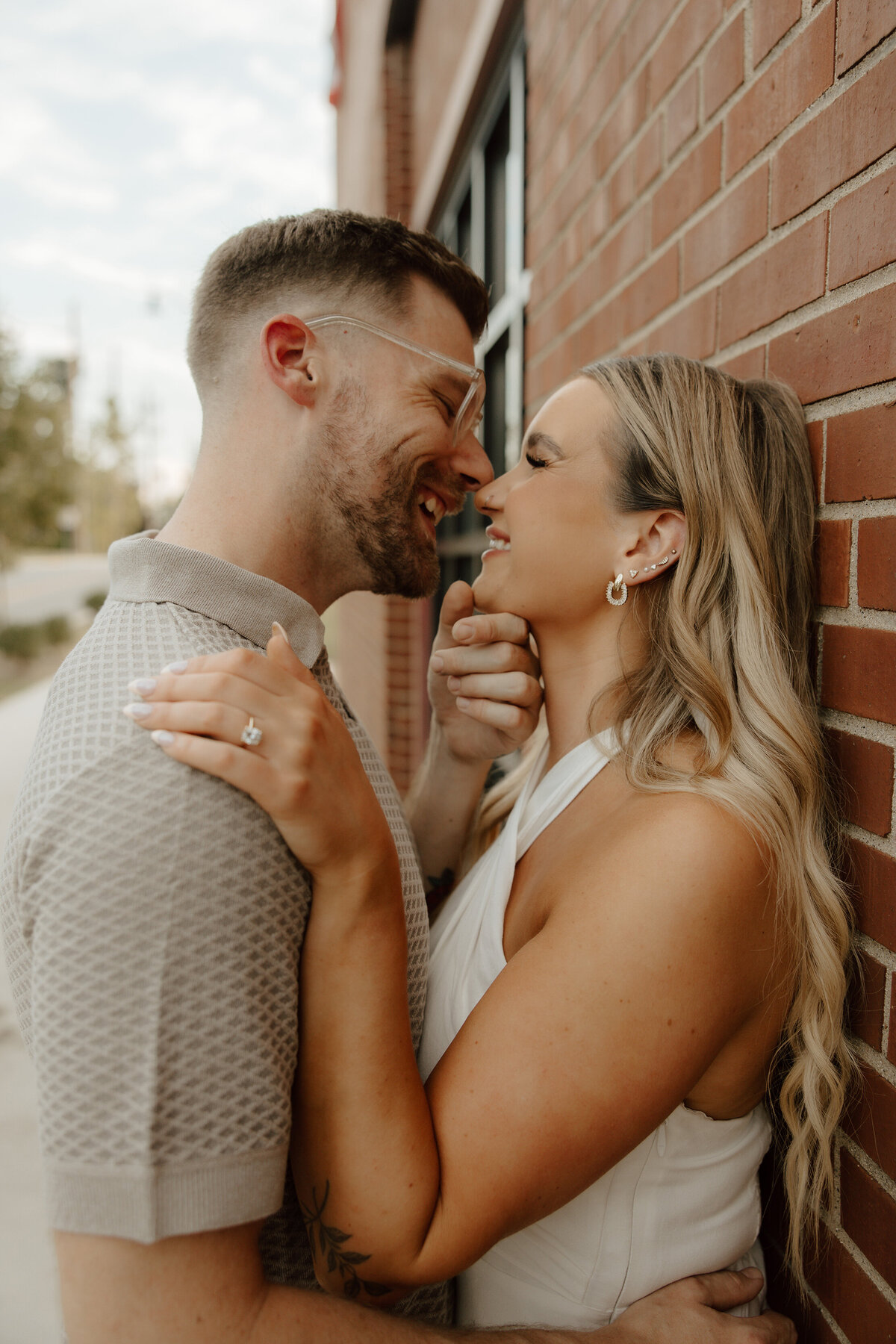 couple-smiling-brick-wall-meg-pearson-photography-midwest