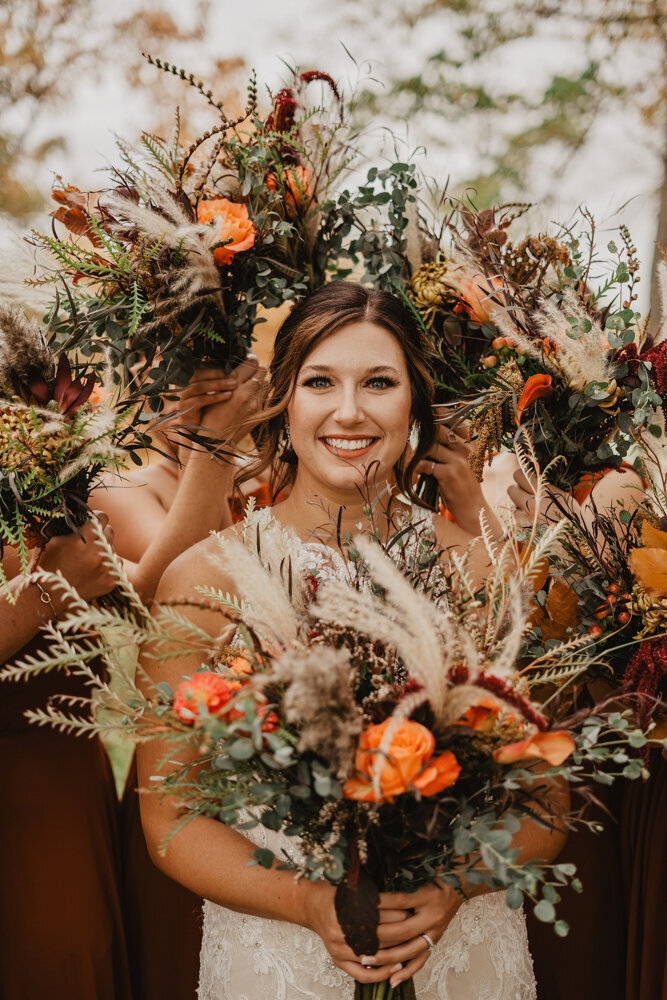 storyteller-collective-photo-co-bride-with-autumn-bouquet-closeup-hickory-grove-park-colo-iowa