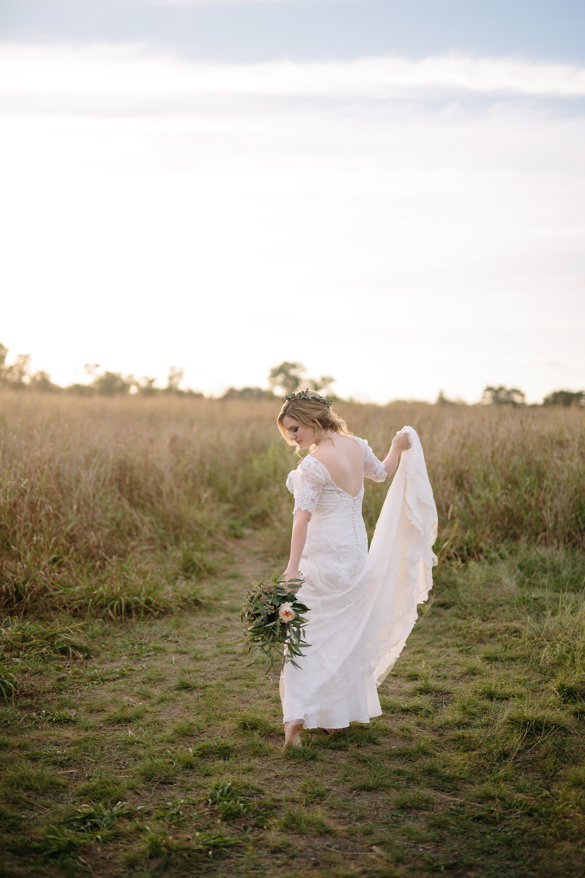 Bride walking through a field barefoot somewhere in San Antonio