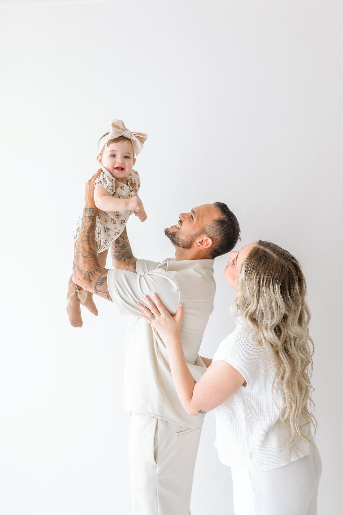parents holding baby in hair