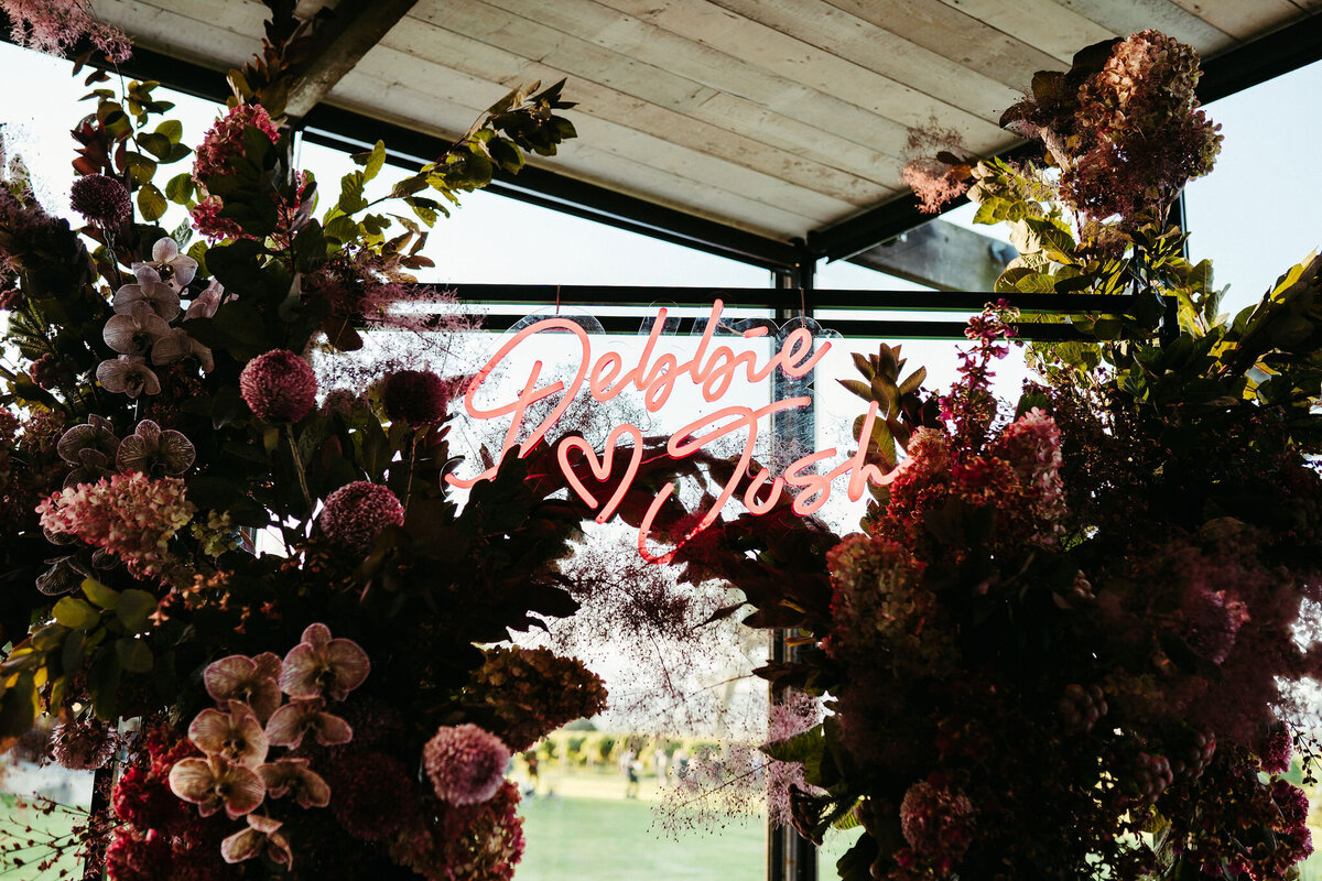 Neon sign on the wedding arbour used as a photo backdrop at Stones
