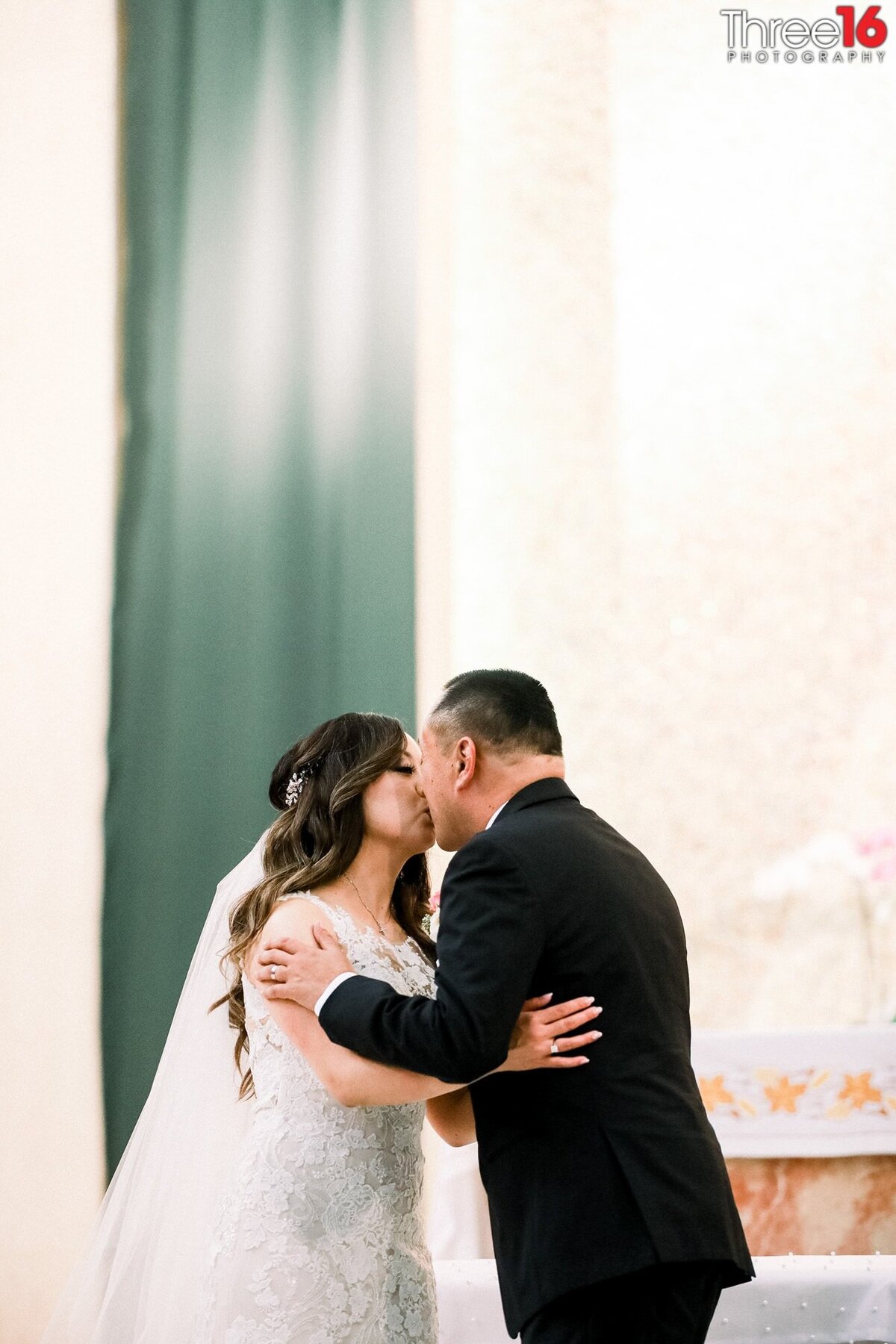 Bride and Groom share their first kiss at the altar as Husband and Wife