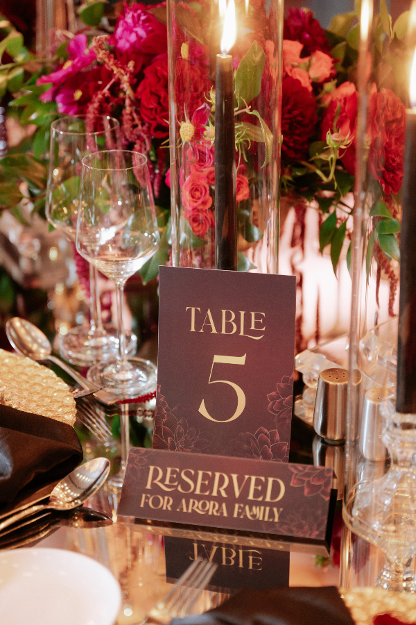 black-gold-pink-burgundy-wedding-reception-candles-roses-stationery-table-numbers-reserved-signs