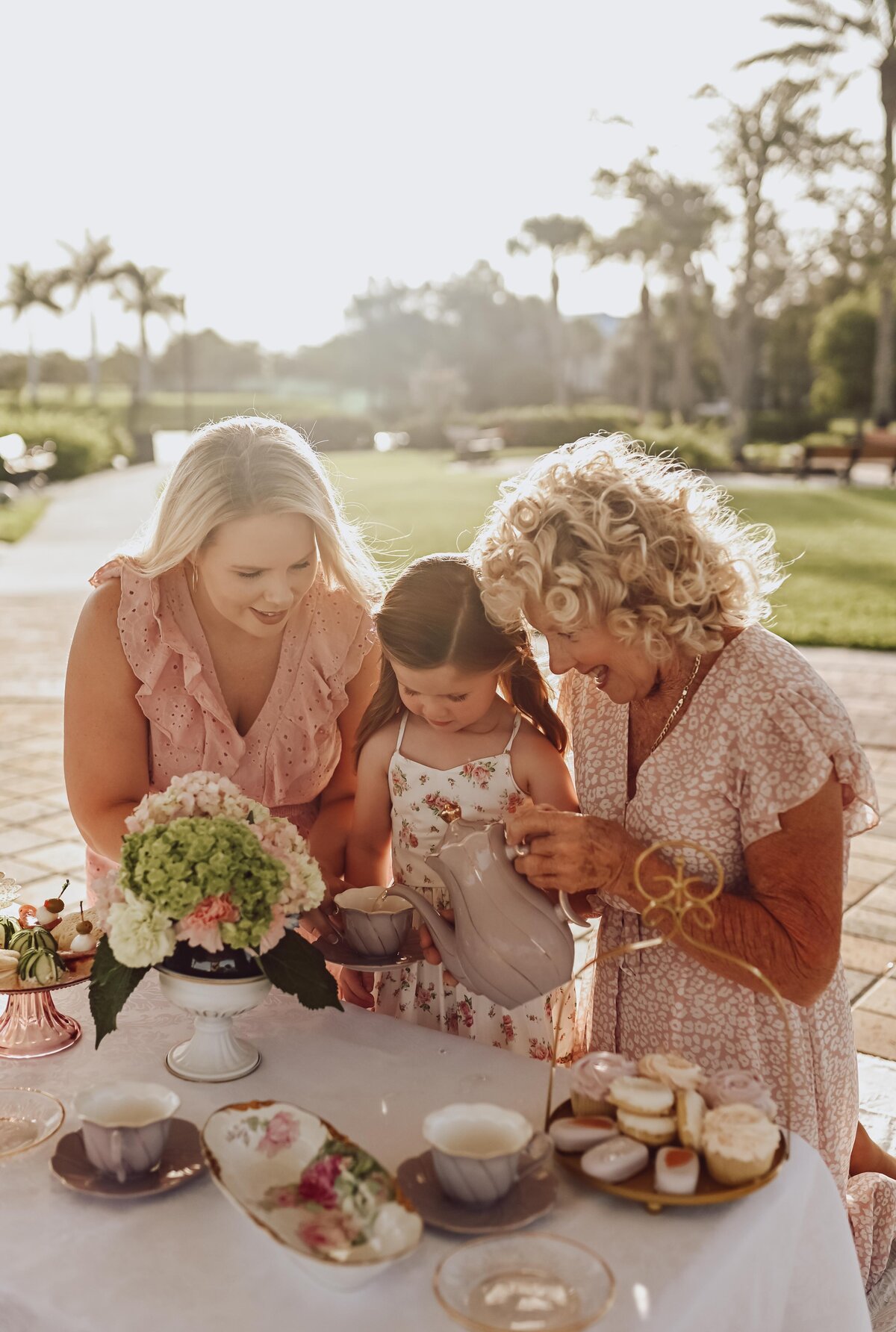 three generations having tea in pink