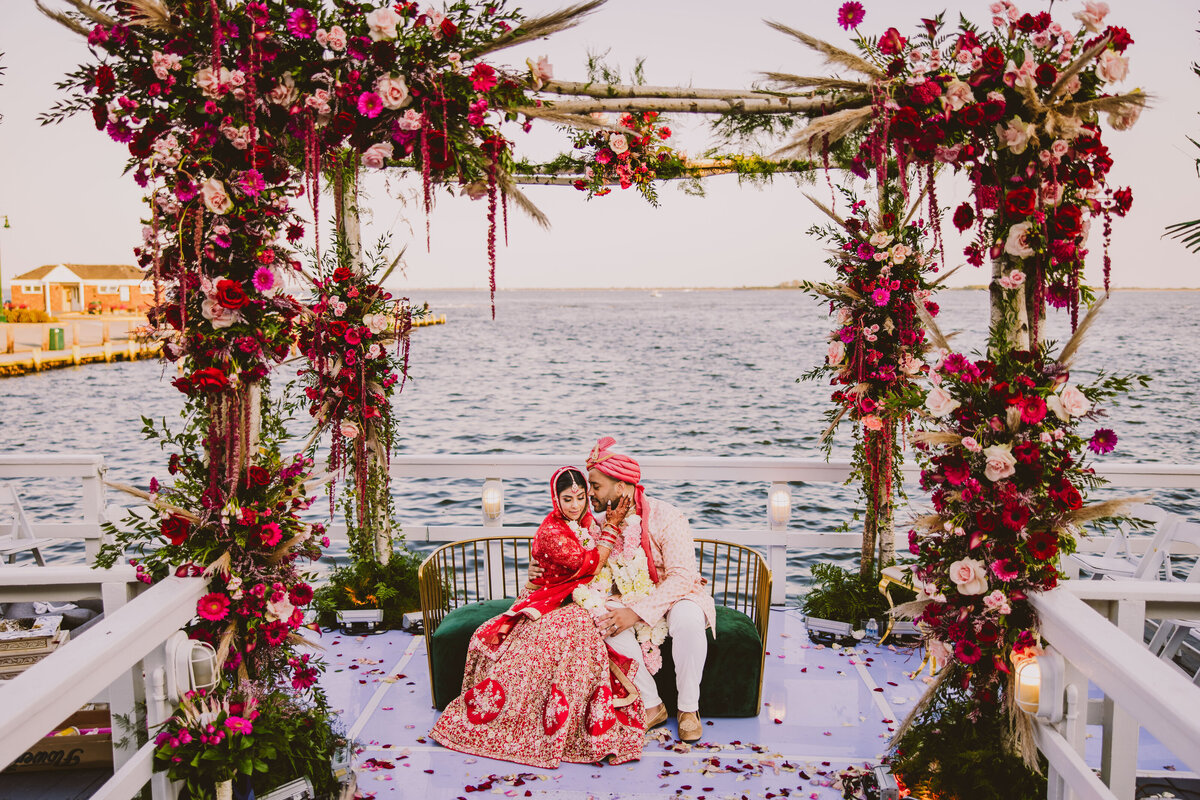 mixed indian black fusion bride and groom share a moment under the mandap by the water at chateau la mer in long island after the hindu ceremony